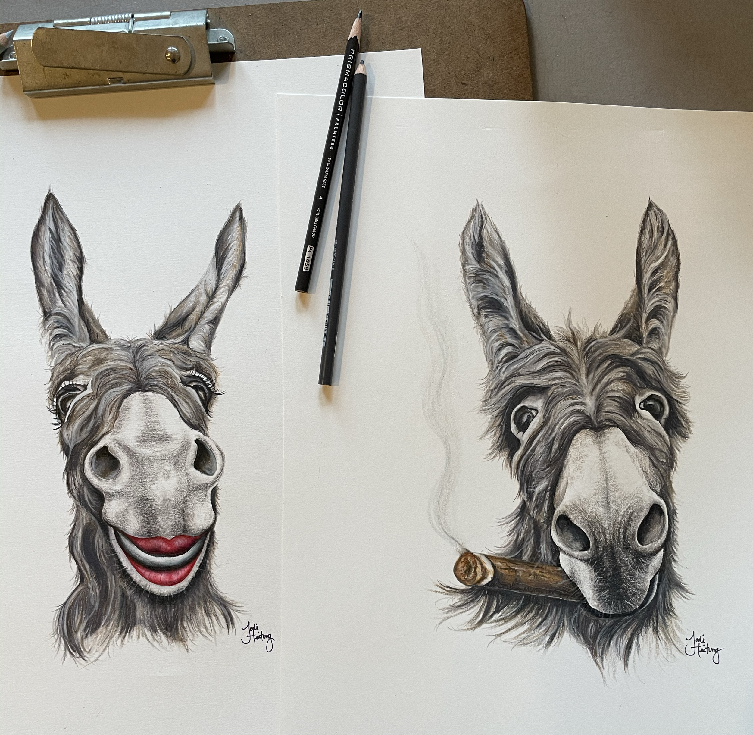 A painting of a donkey, depicted in a realistic style, with one of its ears painted to resemble the clown face of Pennywise from Stephen King's It. Two pencils are placed on the painting, and a metal clip is at the top left corner. The artist's signature, "Jodi Hetting," is at the bottom.