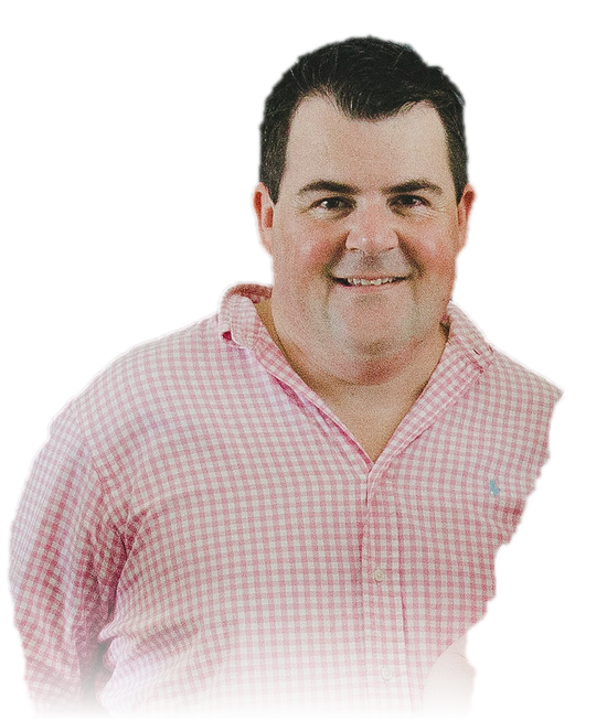 Jon Bowly, smiling, in a pink checked shirt