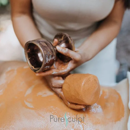 Aesthetician applying Pure Sculpt to woman's back