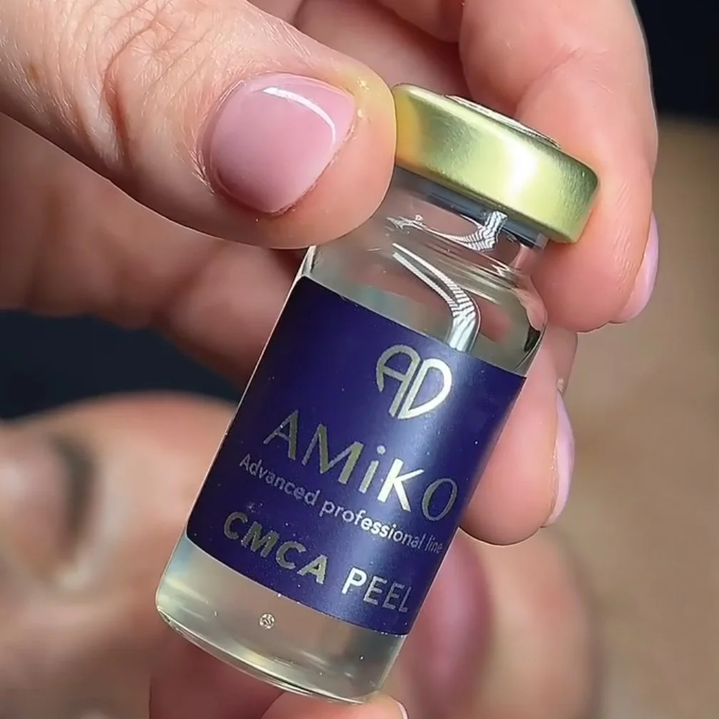 Hand holding bottle of Amiko chemical peel