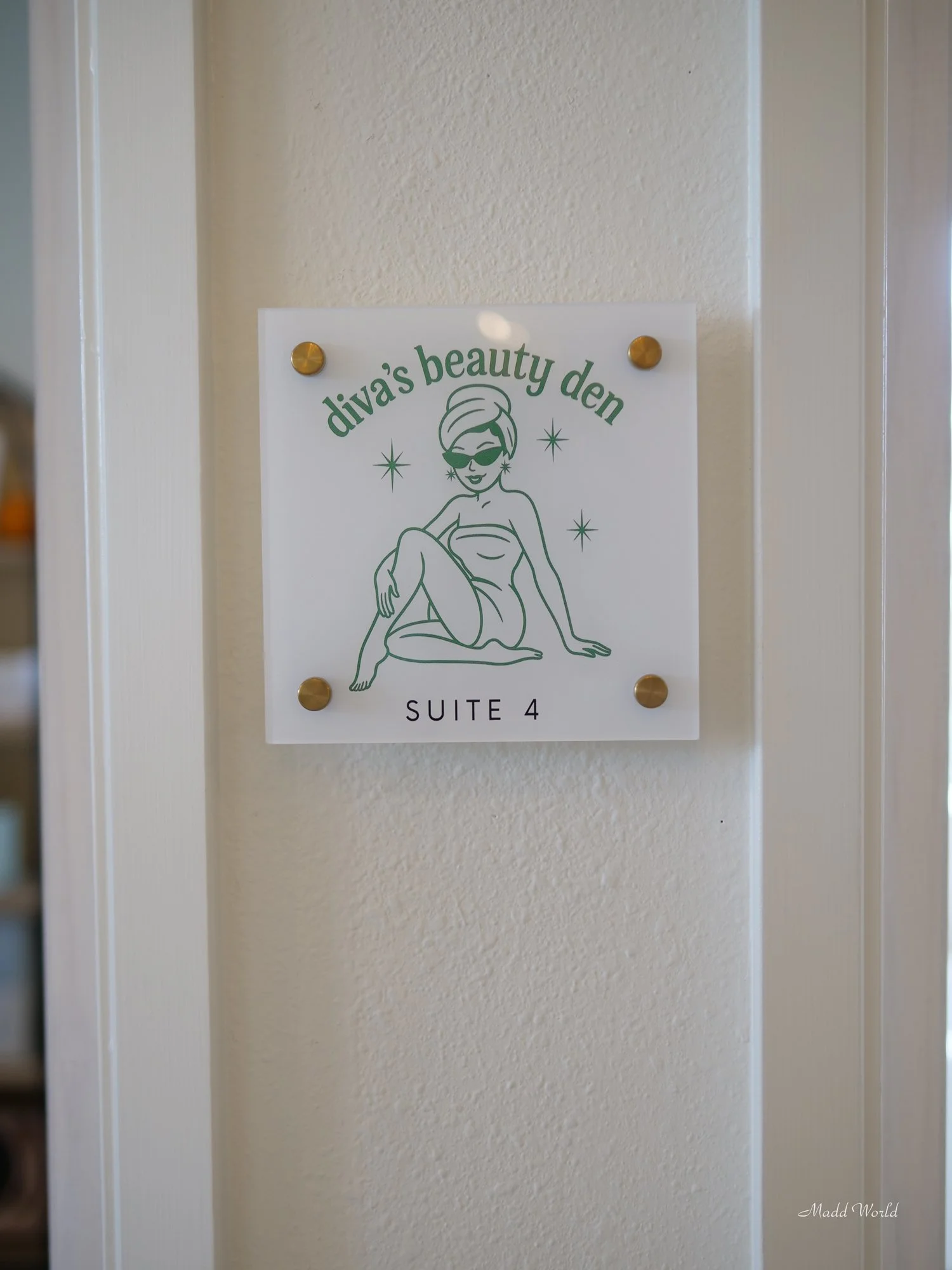 Diva's Beauty Den sign outside door