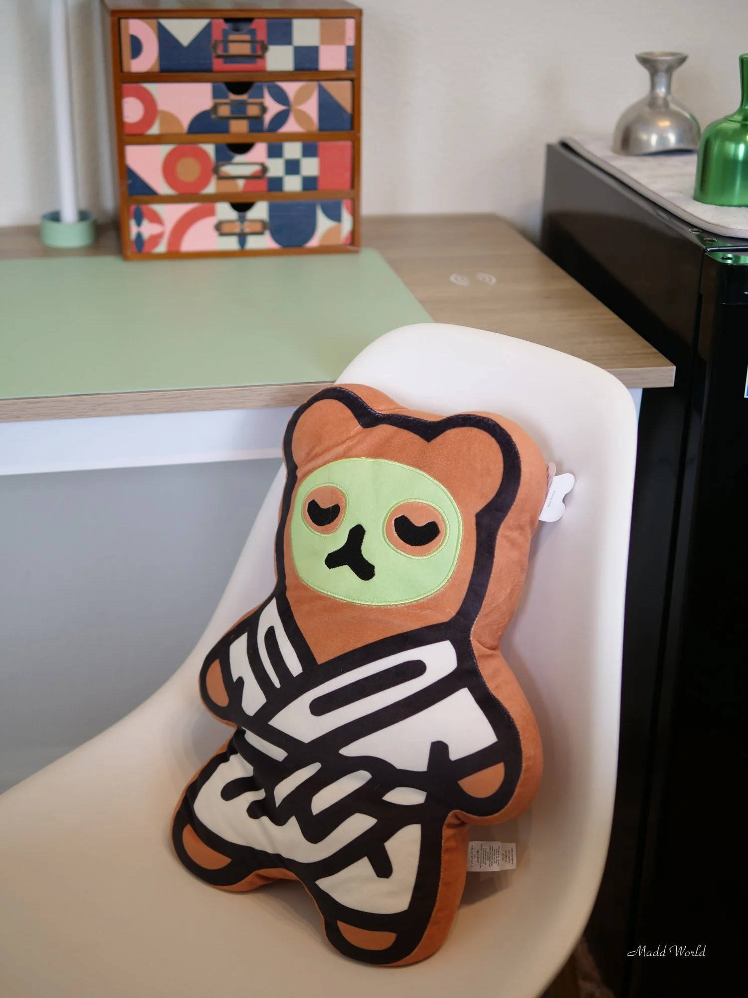 Plush spa bear sitting in white chair