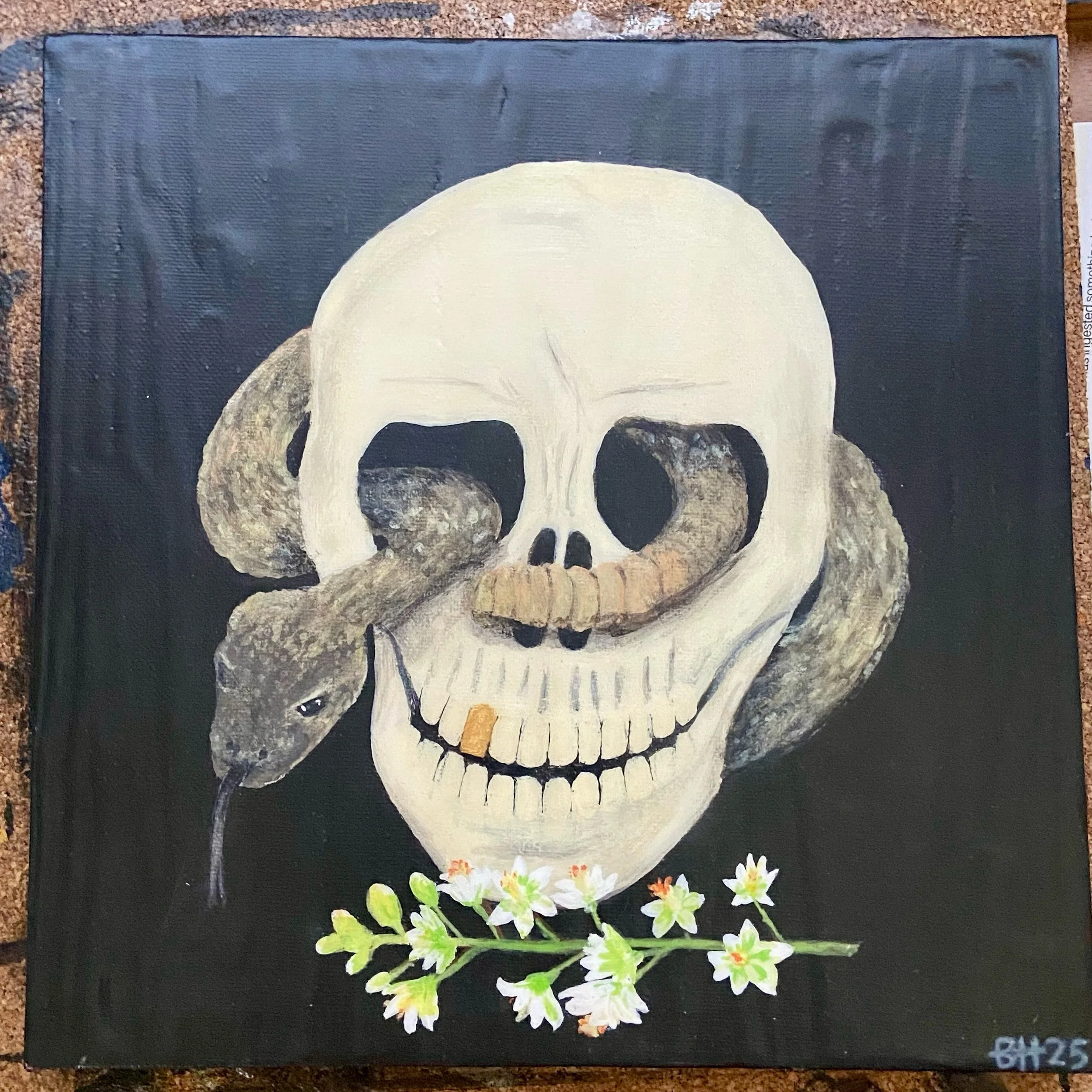 Painting of a human skull with a snake wrapped around it and a dead rat hanging from the snake's mouth, with white flowers at the bottom.