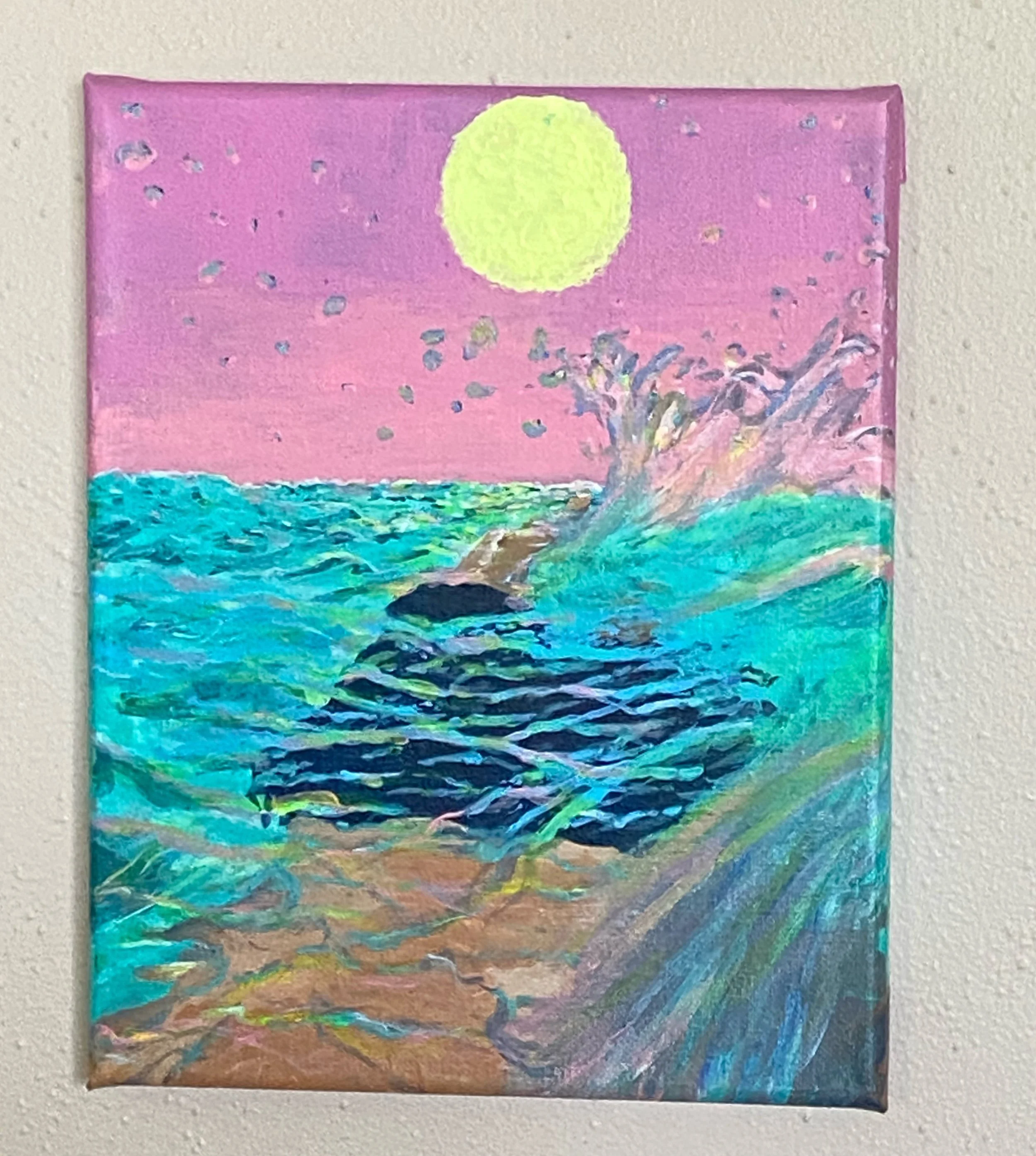 A colorful painting of ocean waves crashing onto a rocky shoreline moonlit sky with pink and purple hues.