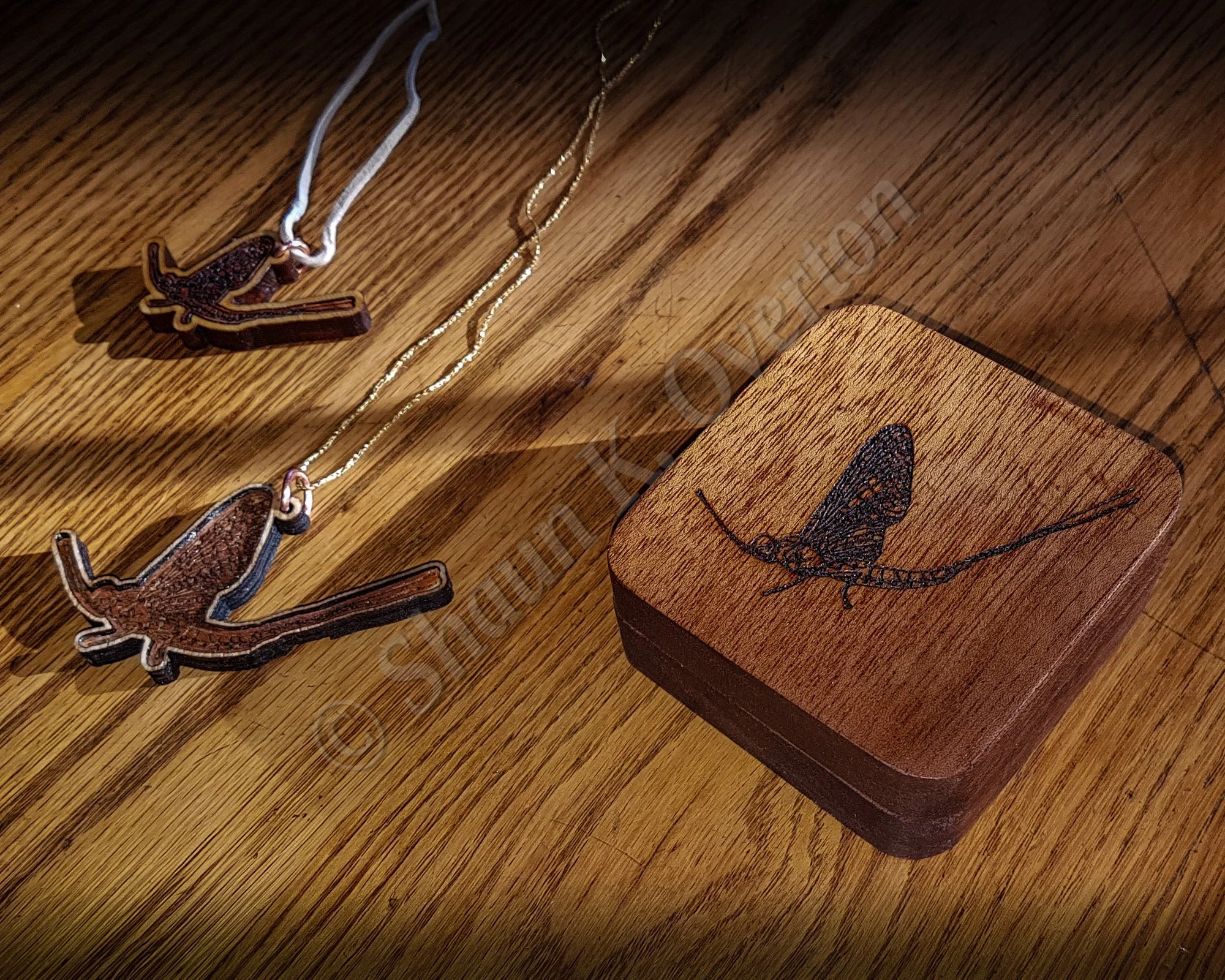 Crafted mahogany box with pendants.