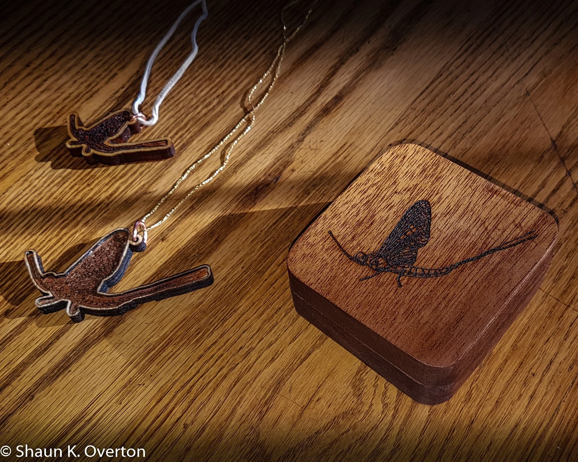 Crafted mahogany box with pendants.