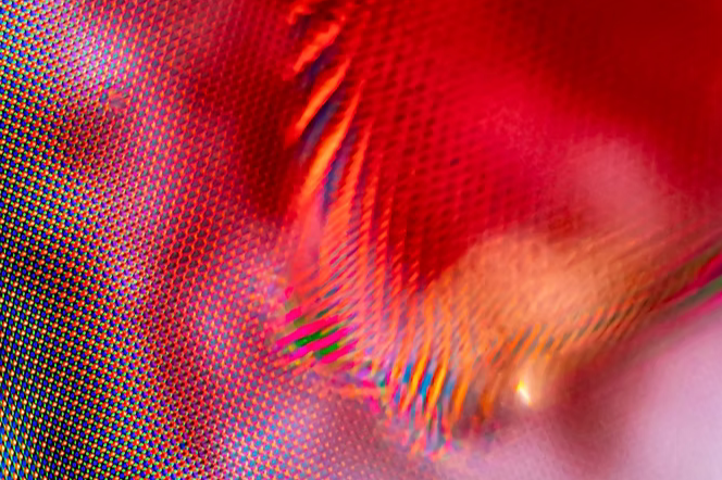 Close-up of colorful digital screen with a pattern of red, orange, pink, and green hues.