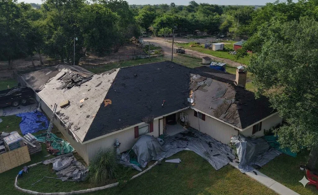 Tear-off stage of a full residential roof replacement following severe hail and wind storm damage in Northeast Texas by Strawn Roofing & Construction Inc.