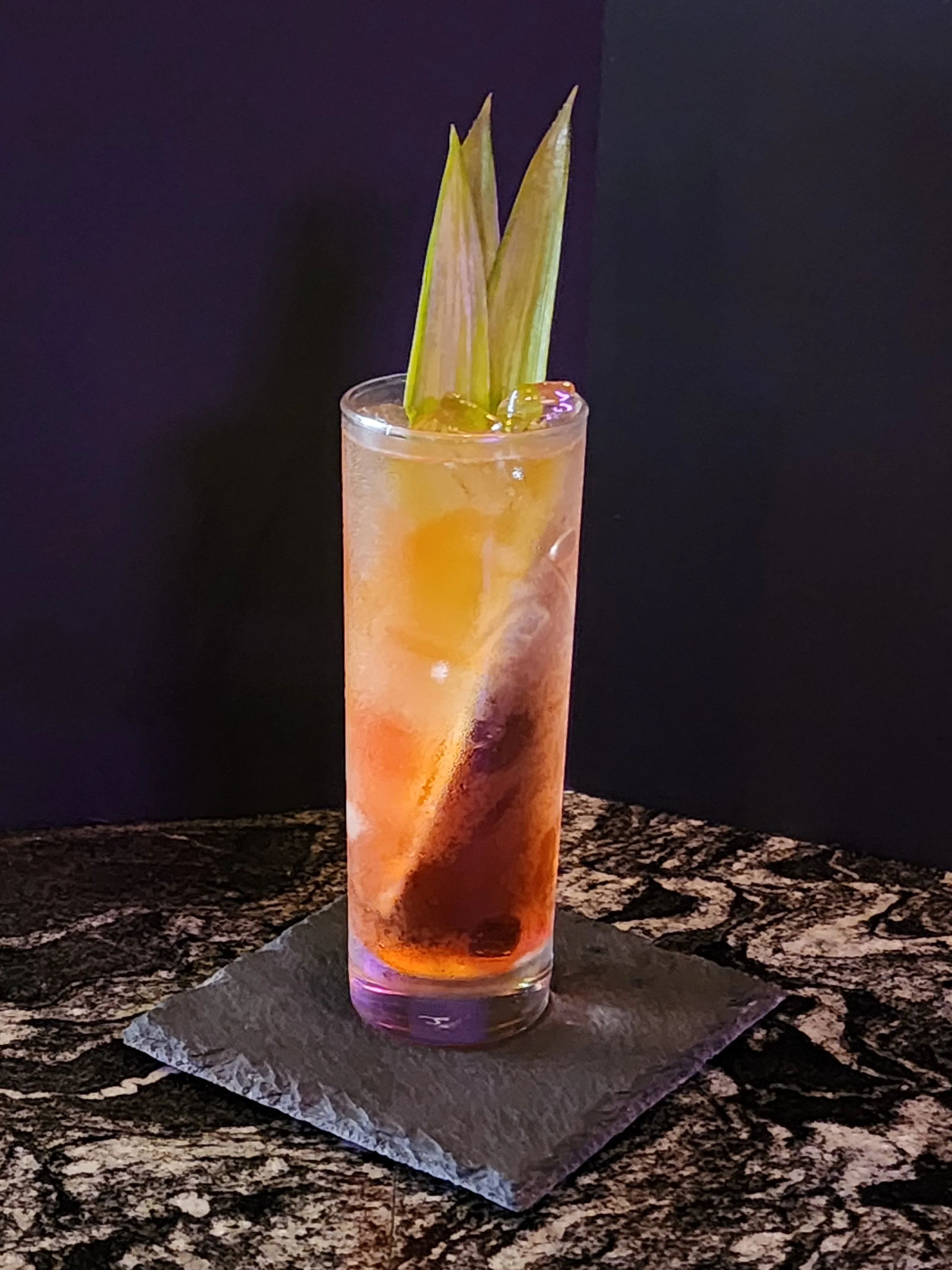 A brown cocktail in a chilled glass