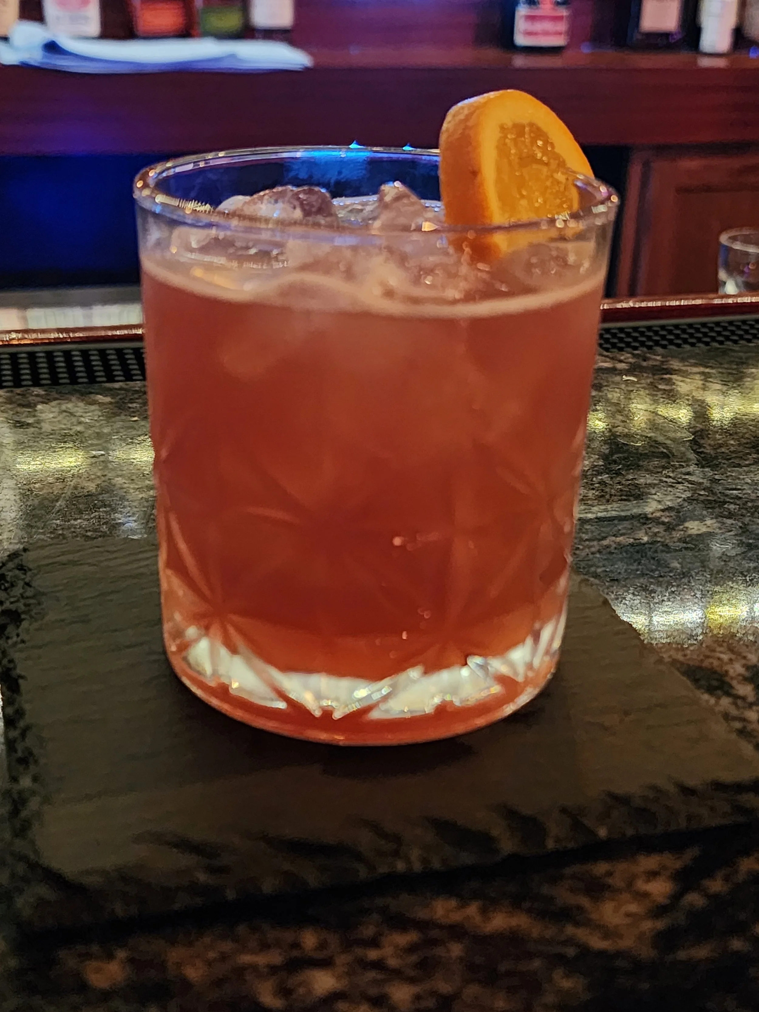 A  red cocktail in a rocks glass