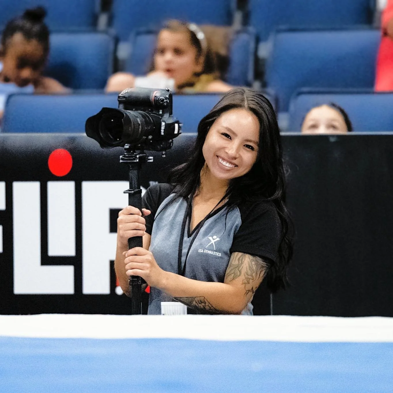 Professional sports photographer Allison Mott, formerly Allison Cheng, photographing the USA Gymnastics Championships.