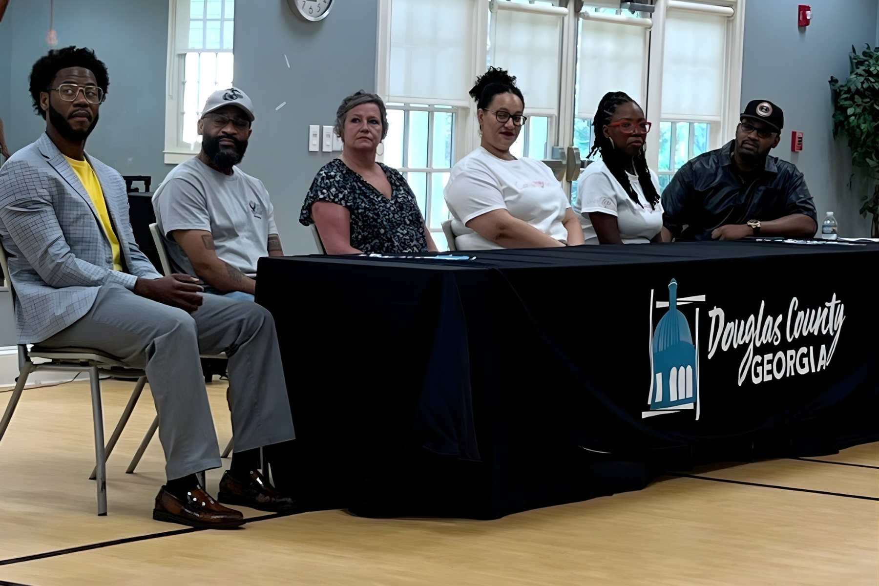 Community members and local leaders, including  Up Giving Village VP, are participating in a partnership meeting focused on serving the community.