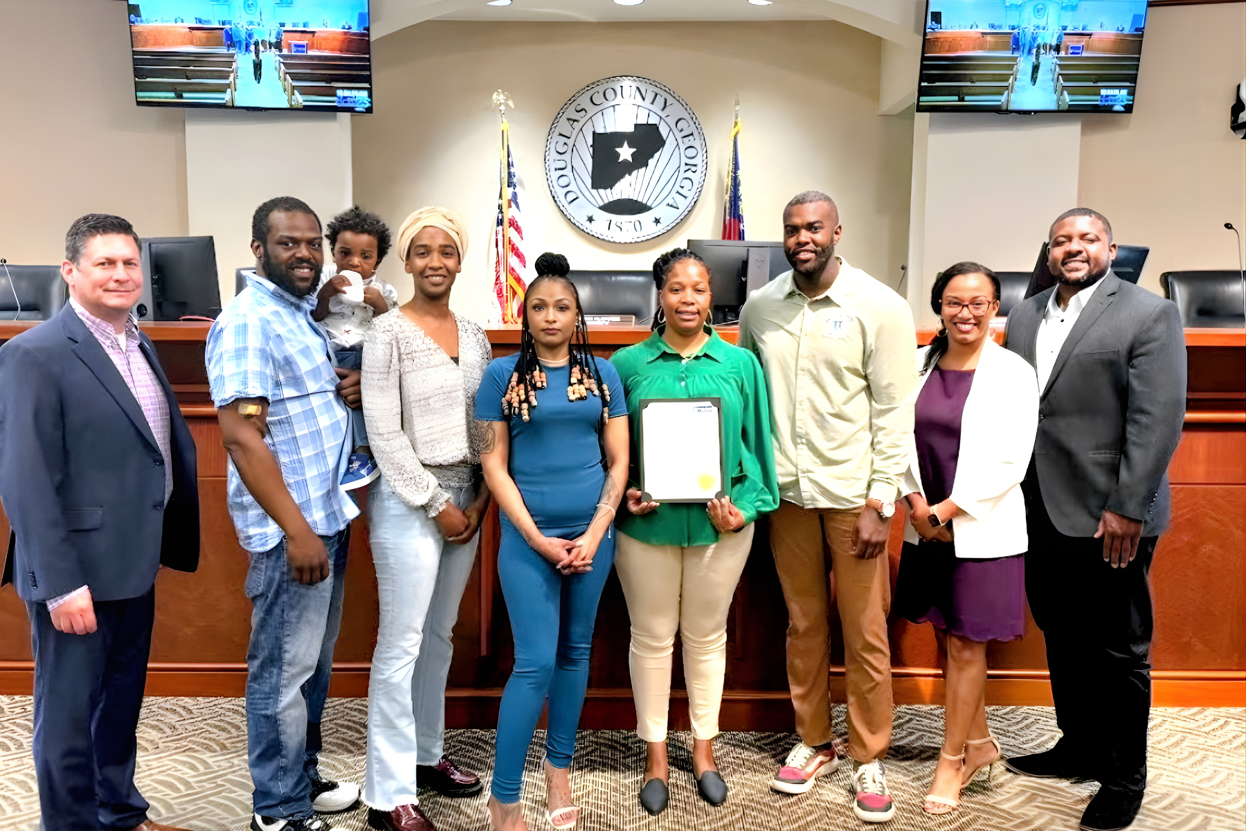 Douglas County Commissioners, Up Giving Village leadership, and community partners during the proclamation of Youth Mental Health Awareness Week.