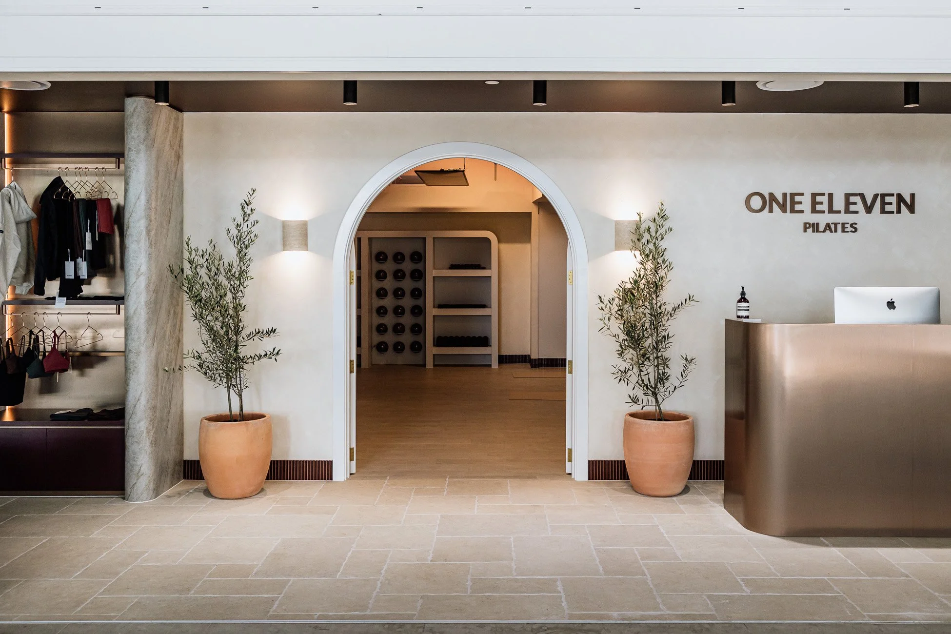 Interior of One Eleven Pilates studio in Scarborough with arched doors and olive trees