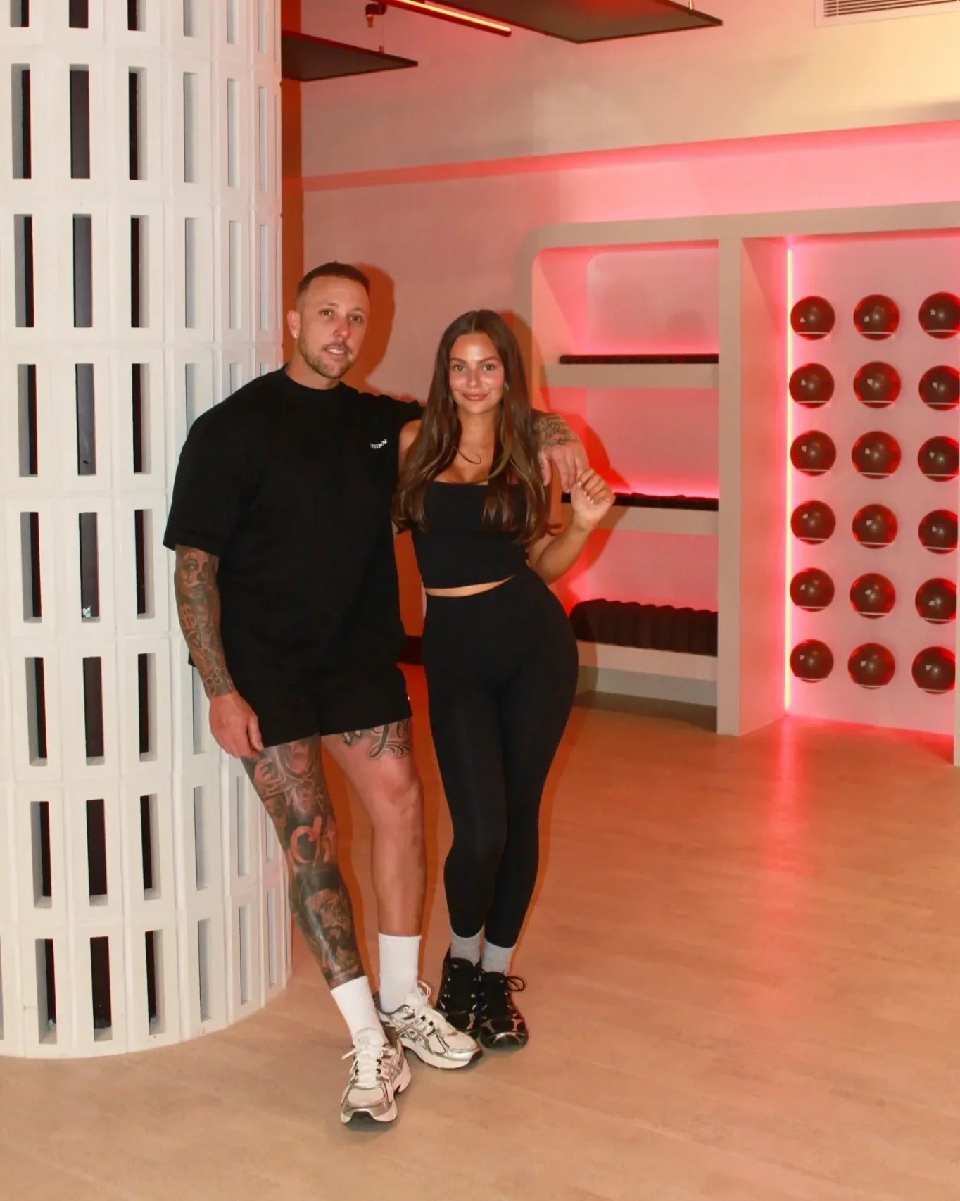 One Eleven Pilates founders Cory and Beth standing together in their Scarborough studio.