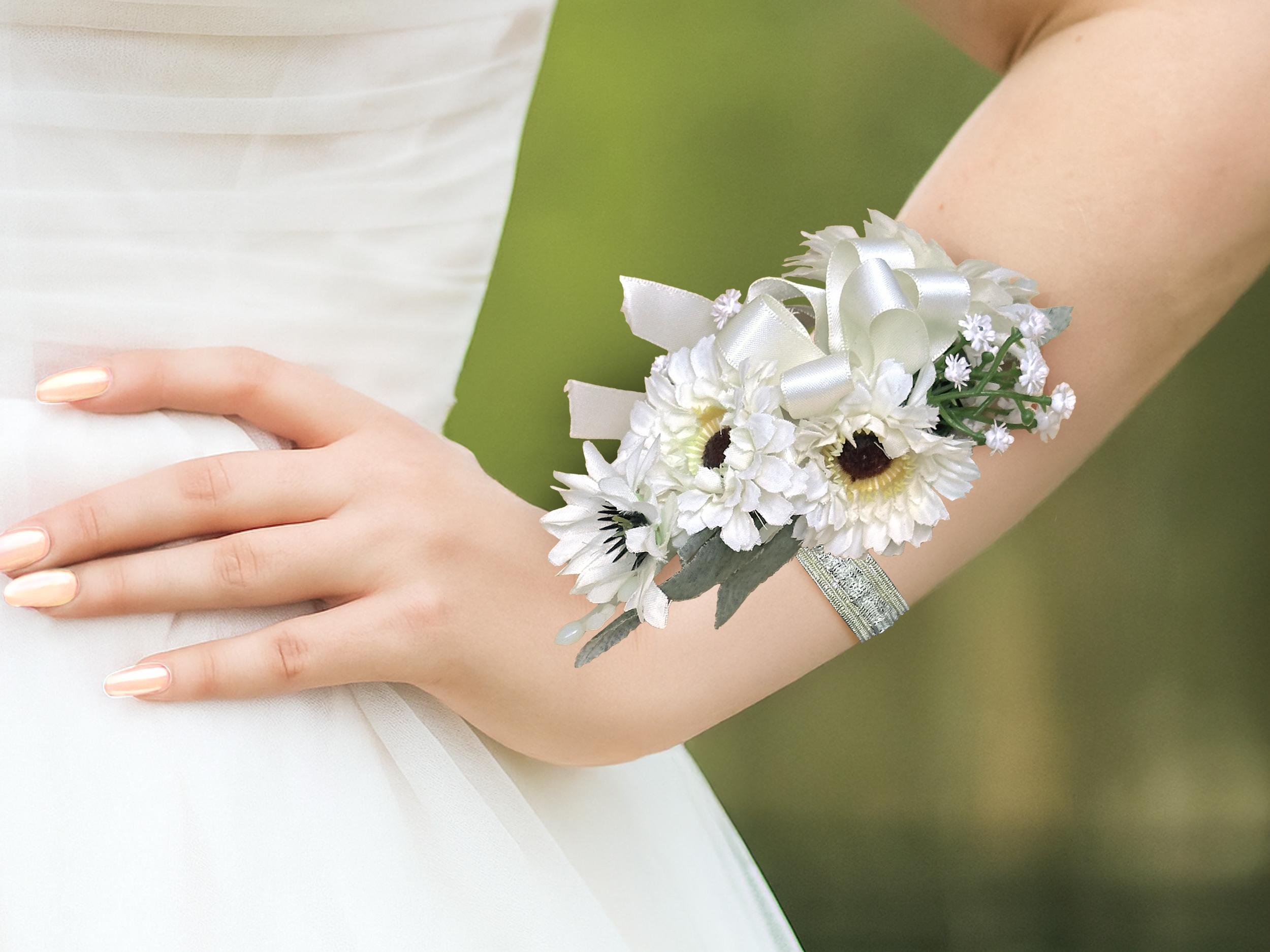 Ivory Daisy corsage on wrist outside.png