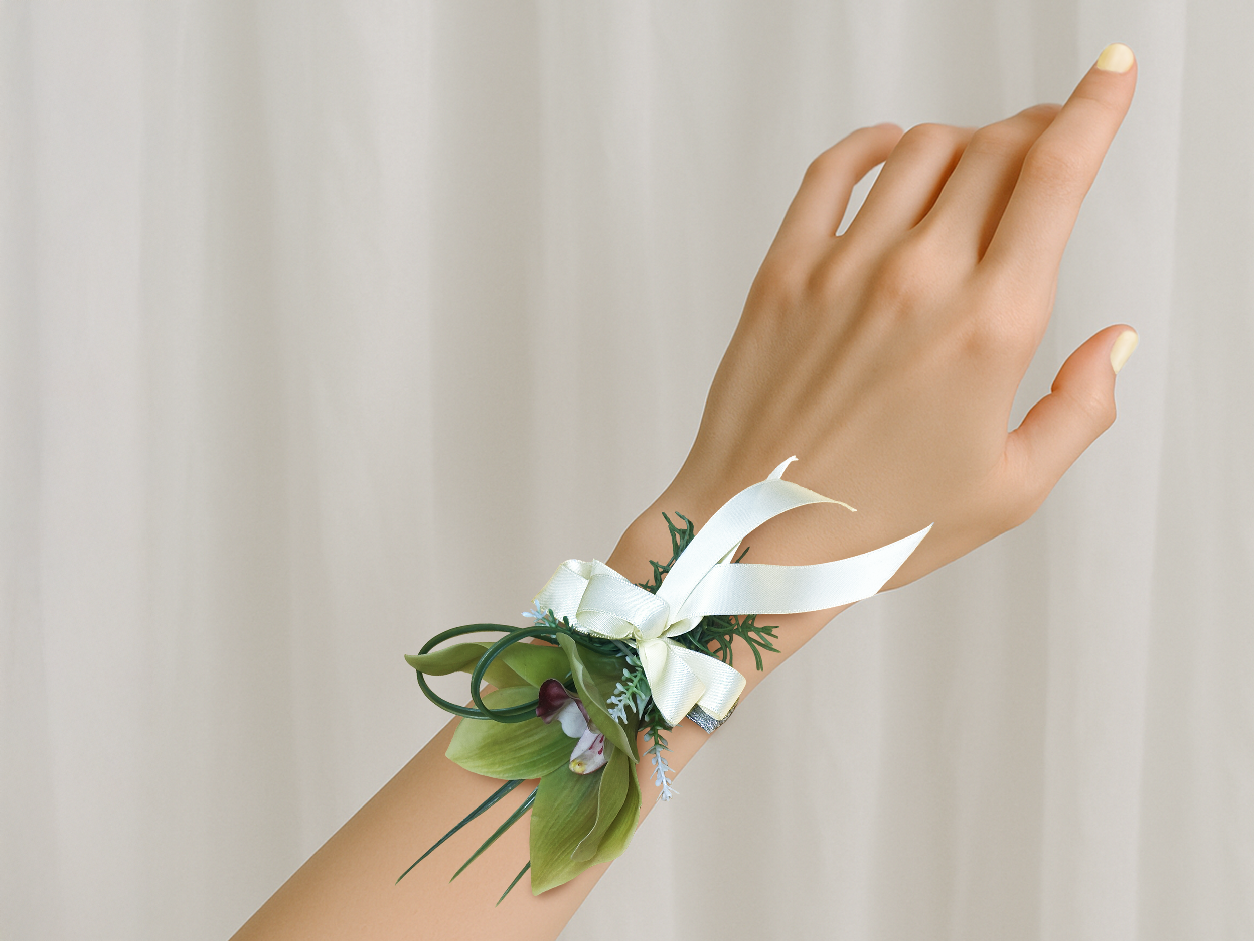 Green and white corsage on wrist.png