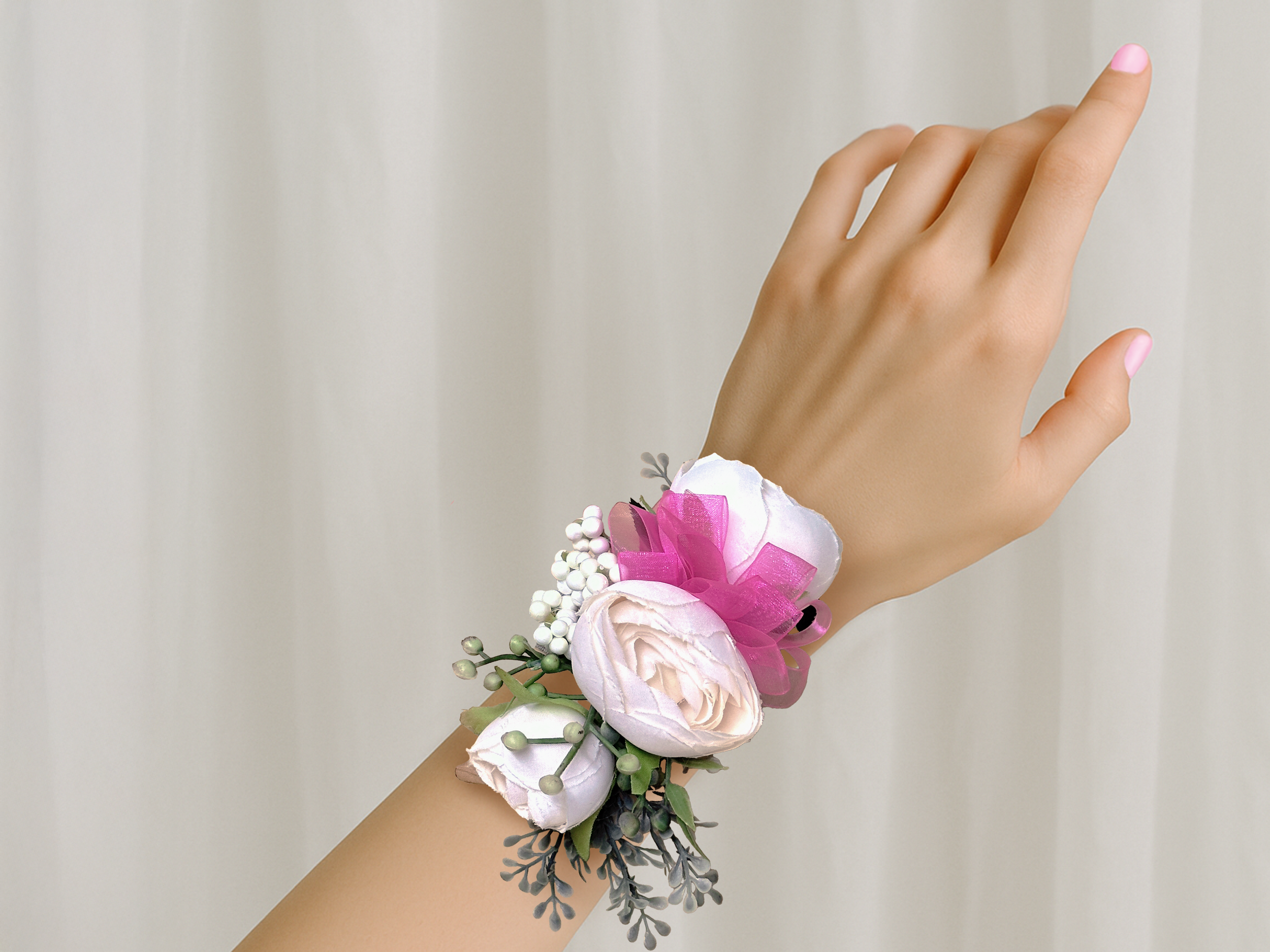 Blush pink corsage on wrist.png