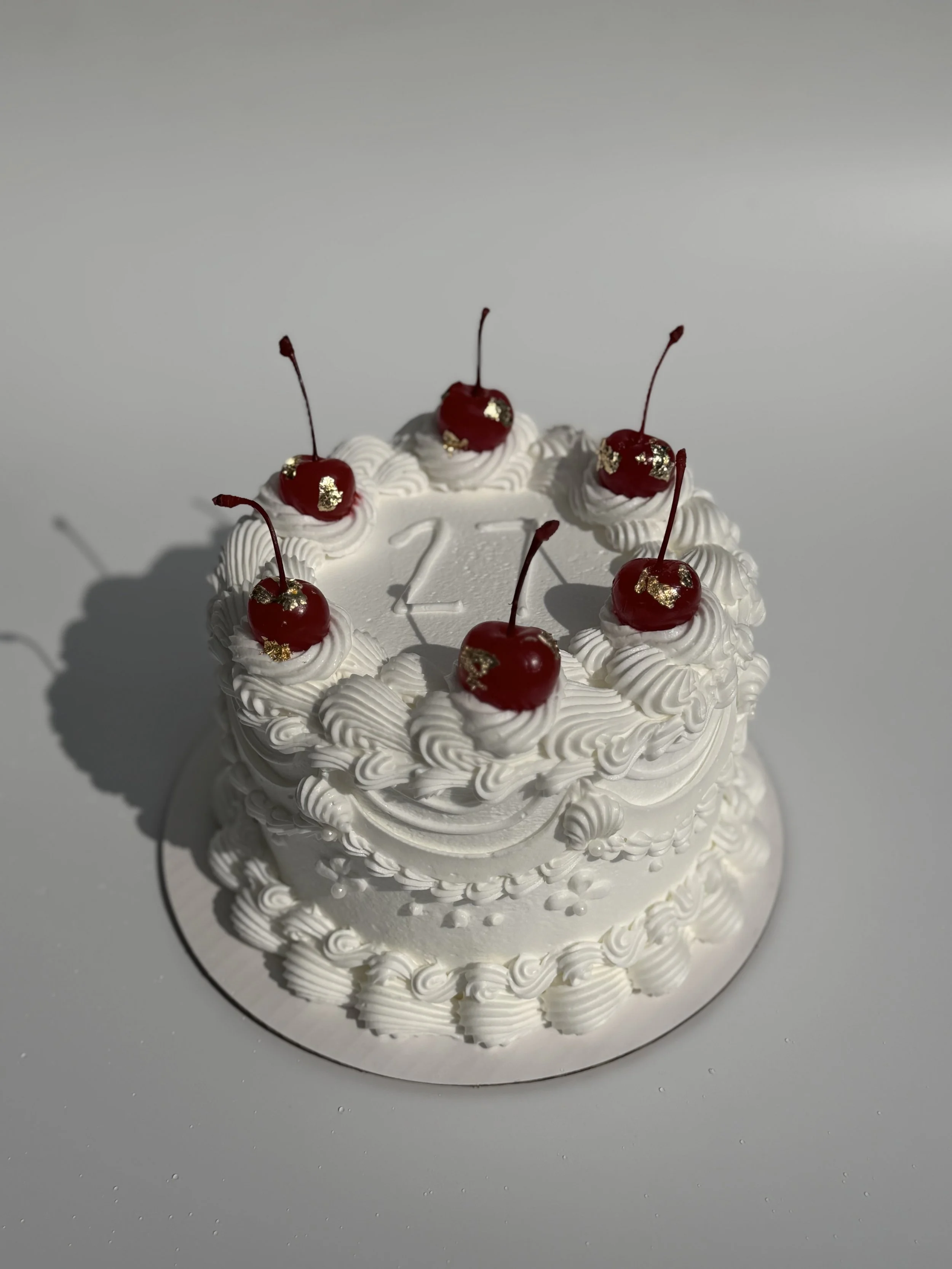 white cake with cherry.jpeg