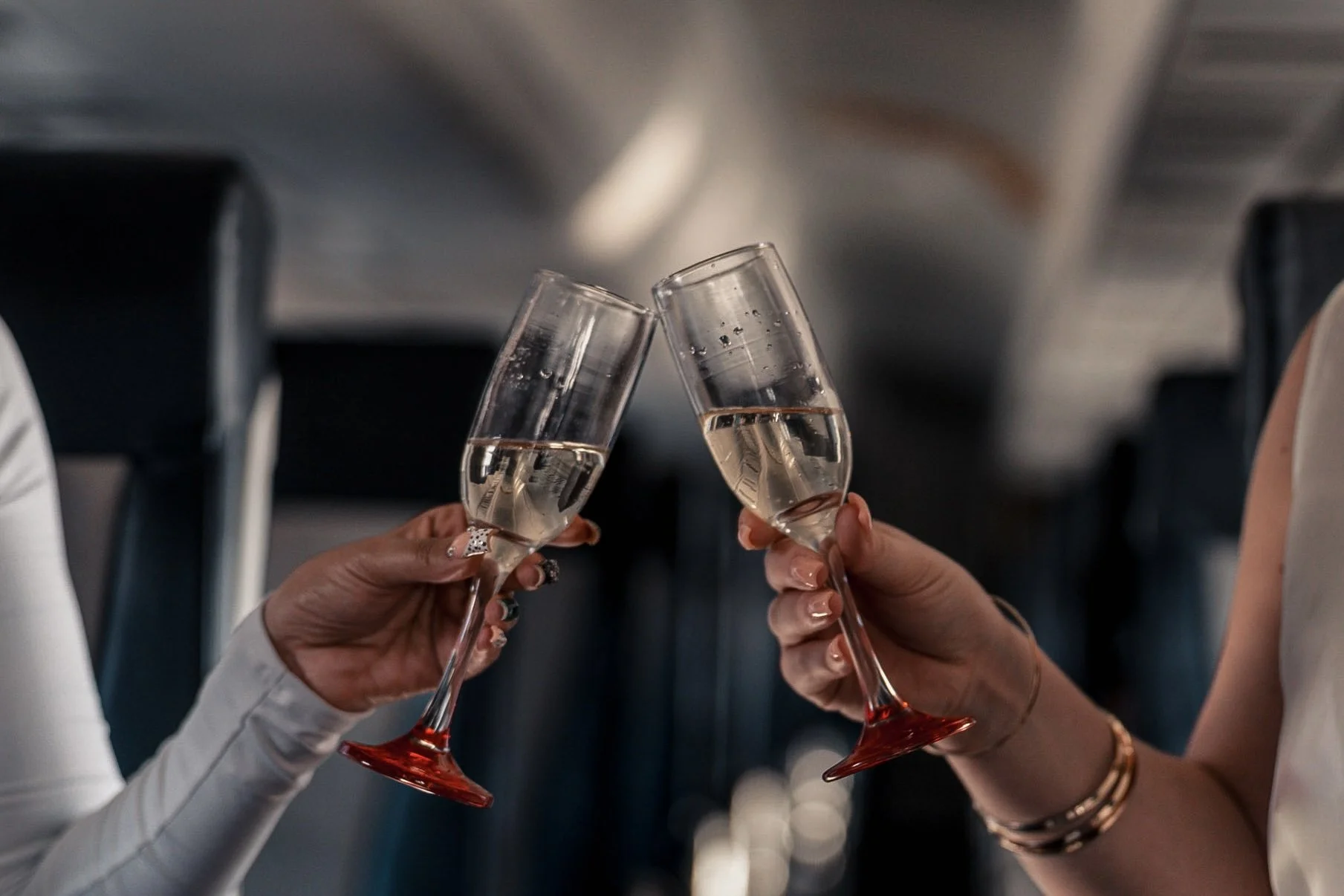 Passengers enjoying champagne aboard an Exodus Aircraft private jet, highlighting luxury, comfort, and elevated travel experience