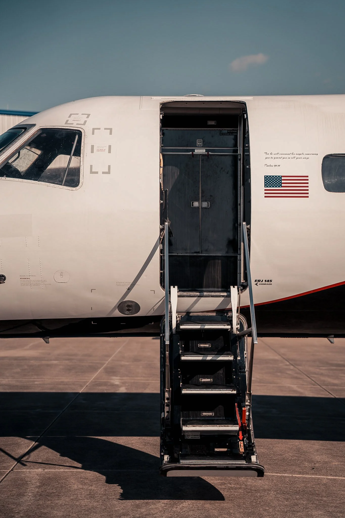 Exodus Aircraft private jet with boarding stairs on airport tarmac, showcasing luxury private jet charter access and seamless travel experience.