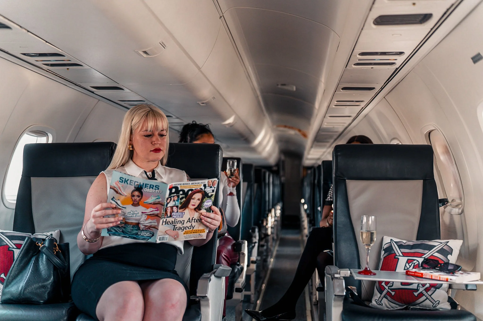 A passenger enjoying a comfortable in-flight experience aboard a private jet, highlighting the spacious seating and relaxed atmosphere offered by Exodus Aircraft. Skip crowded commercial flights and travel in privacy while enjoying a quiet.