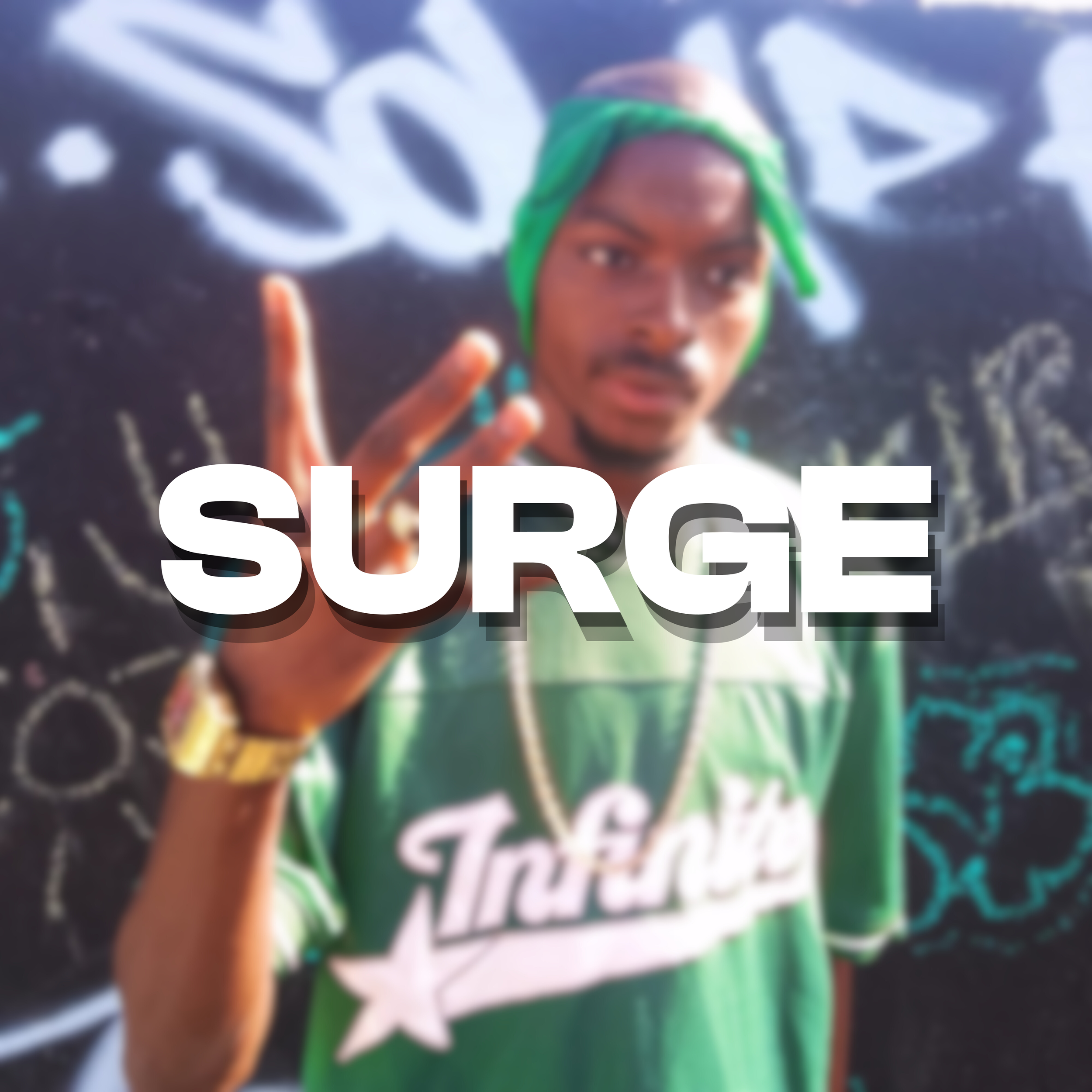 Young man wearing a green T-shirt with the word 'True' and a star, green head wrap, and gold watch, standing in front of a blackboard filled with chalk drawings, making a peace sign with his right hand, with the word 'SURGE' overlaid in bold white text.