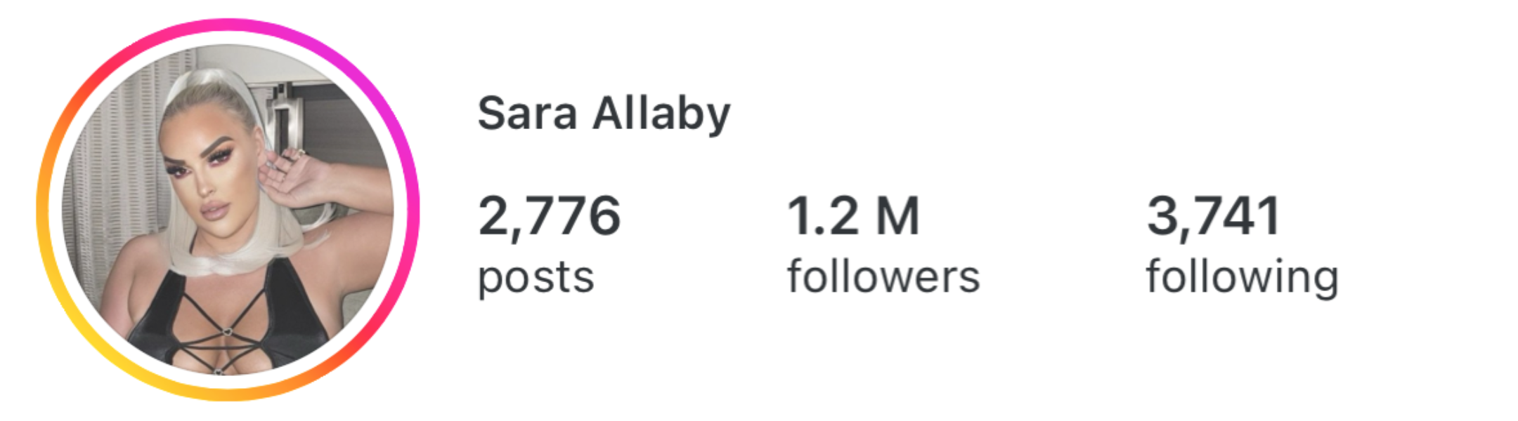 Profile picture of Sara Allaby with platinum blonde hair in a ponytail, makeup, and wearing a black top with strappy design.