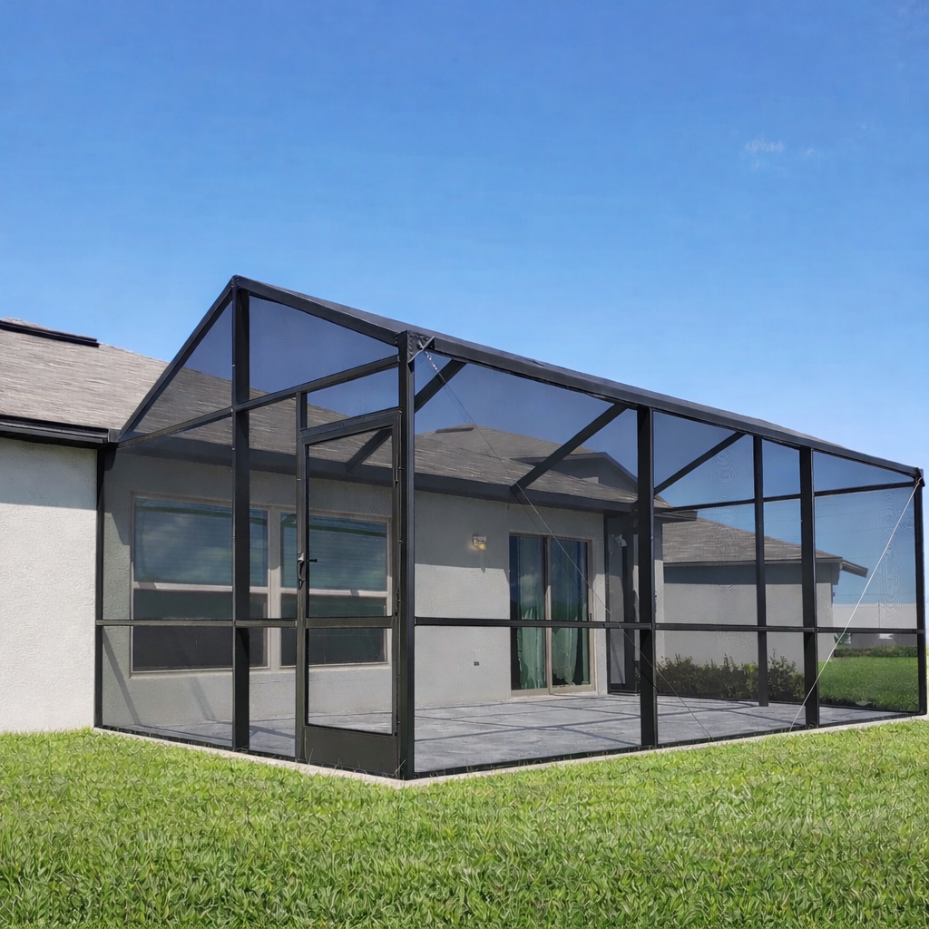 A screened-in patio enclosure attached to a beige house with a sliding glass door and window, surrounded by a green lawn under a clear blue sky.