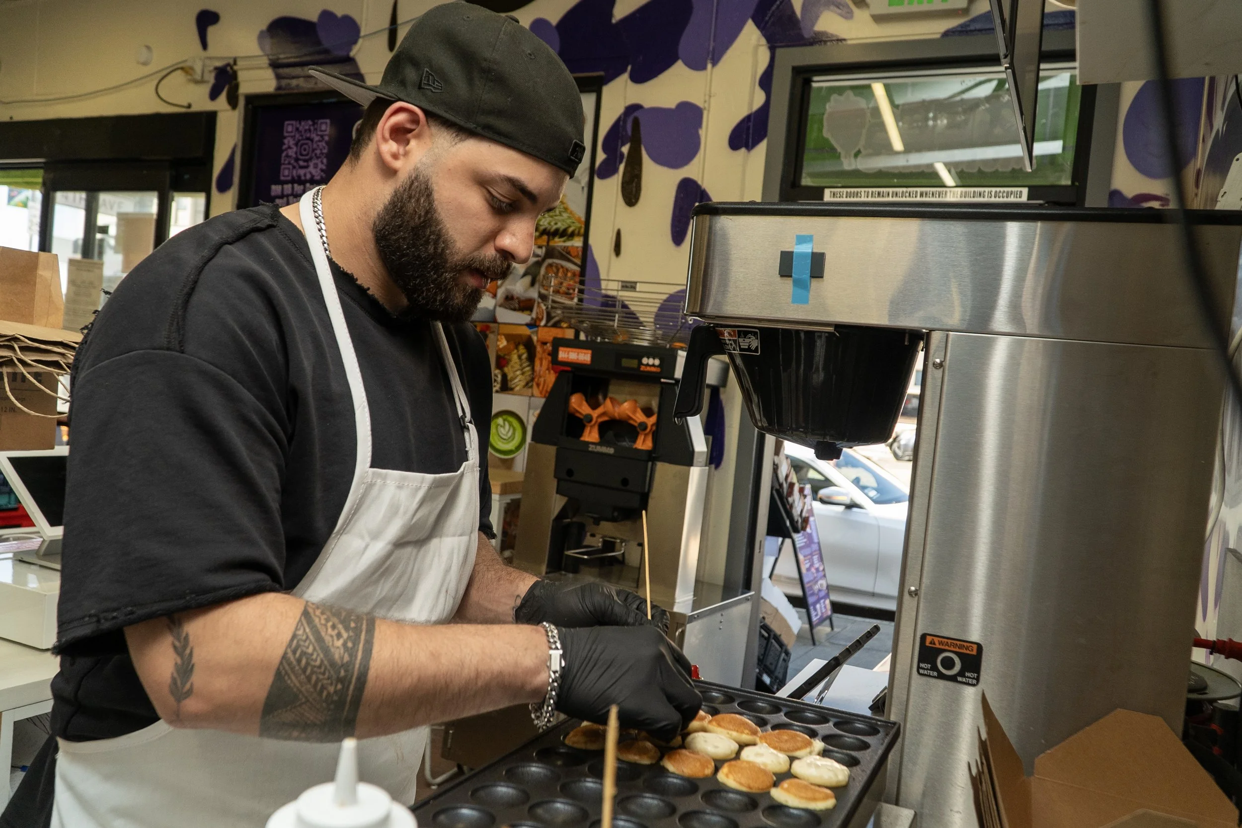  Abood Sluimen makes mini pancakes at Zee’s Munchies in San Francisco on March 21, 2026. (Neal Wong / Richmond Review) 
