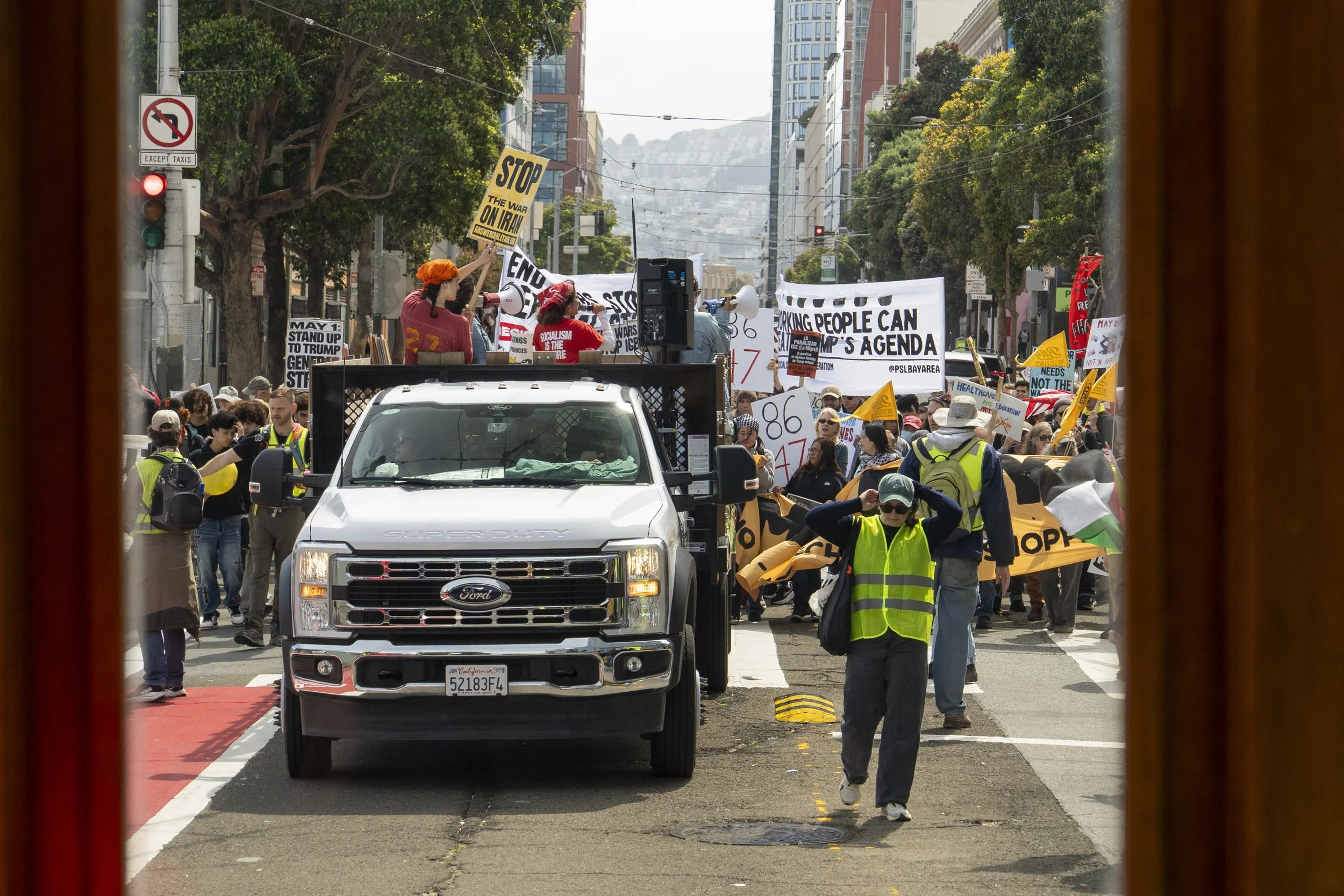  Speakers on a truck lead chants as thousands march down Mission Street during May Day demonstrations against billionaire greed and the Trump administration’s cuts to federal programs serving working communities. (Neal Wong / San Francisco Public Pre