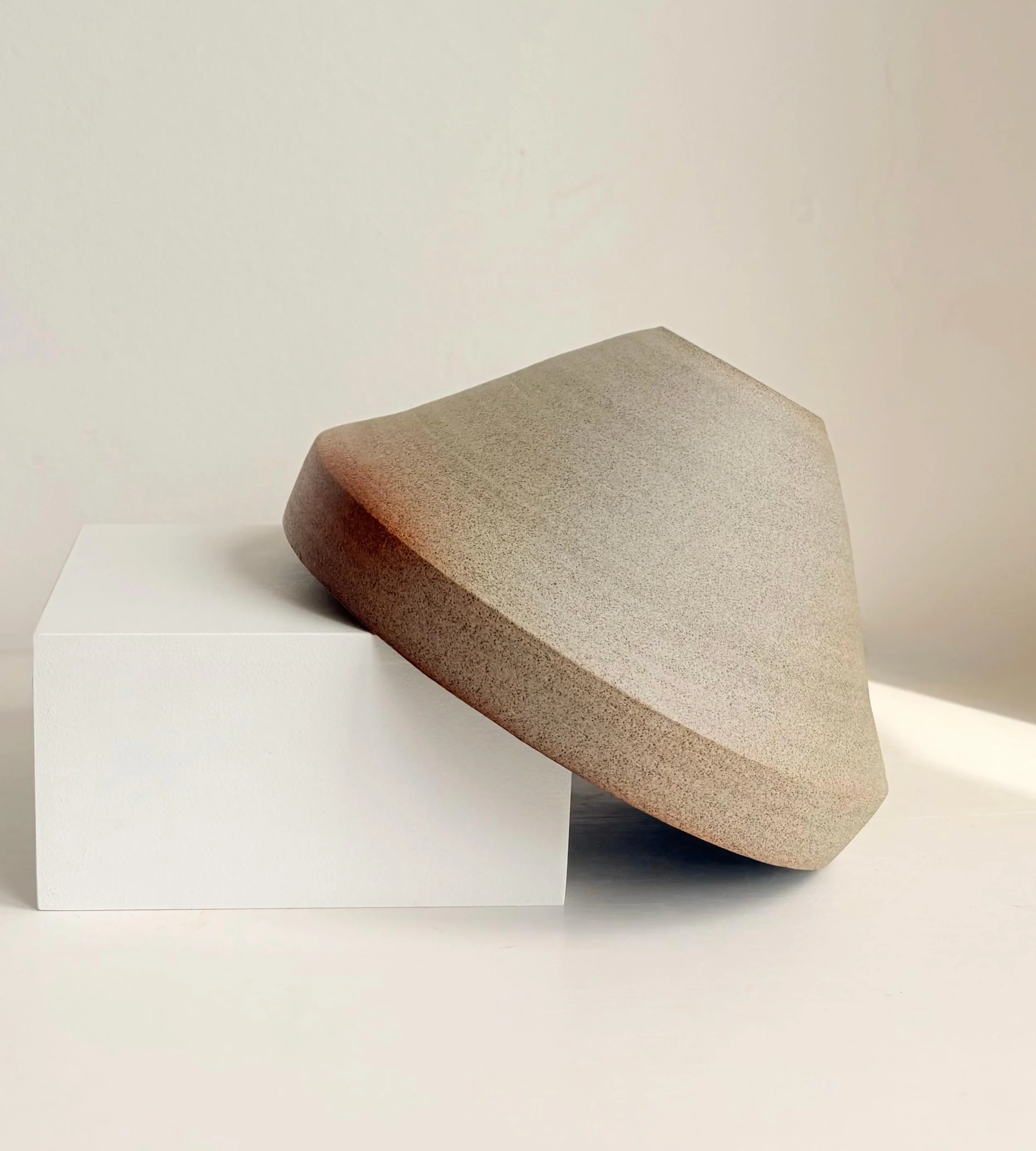 Large sculptural serving bowl thrown on the wheel in grey clay with a black glazed interior. Approximately 21 cm W &times; 12 cm H.

#contemporaryceramics#modernceramics#angularbowl#wheelthrownceramics