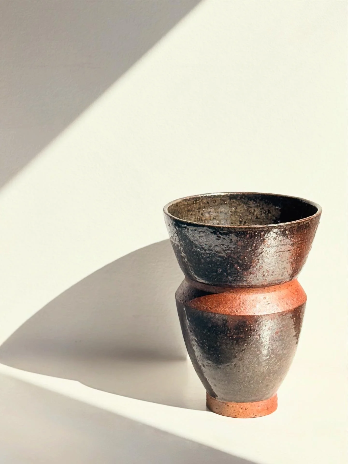 Wood fired vase. The fly ash and flame gave the vase a metallic brown/copper shade