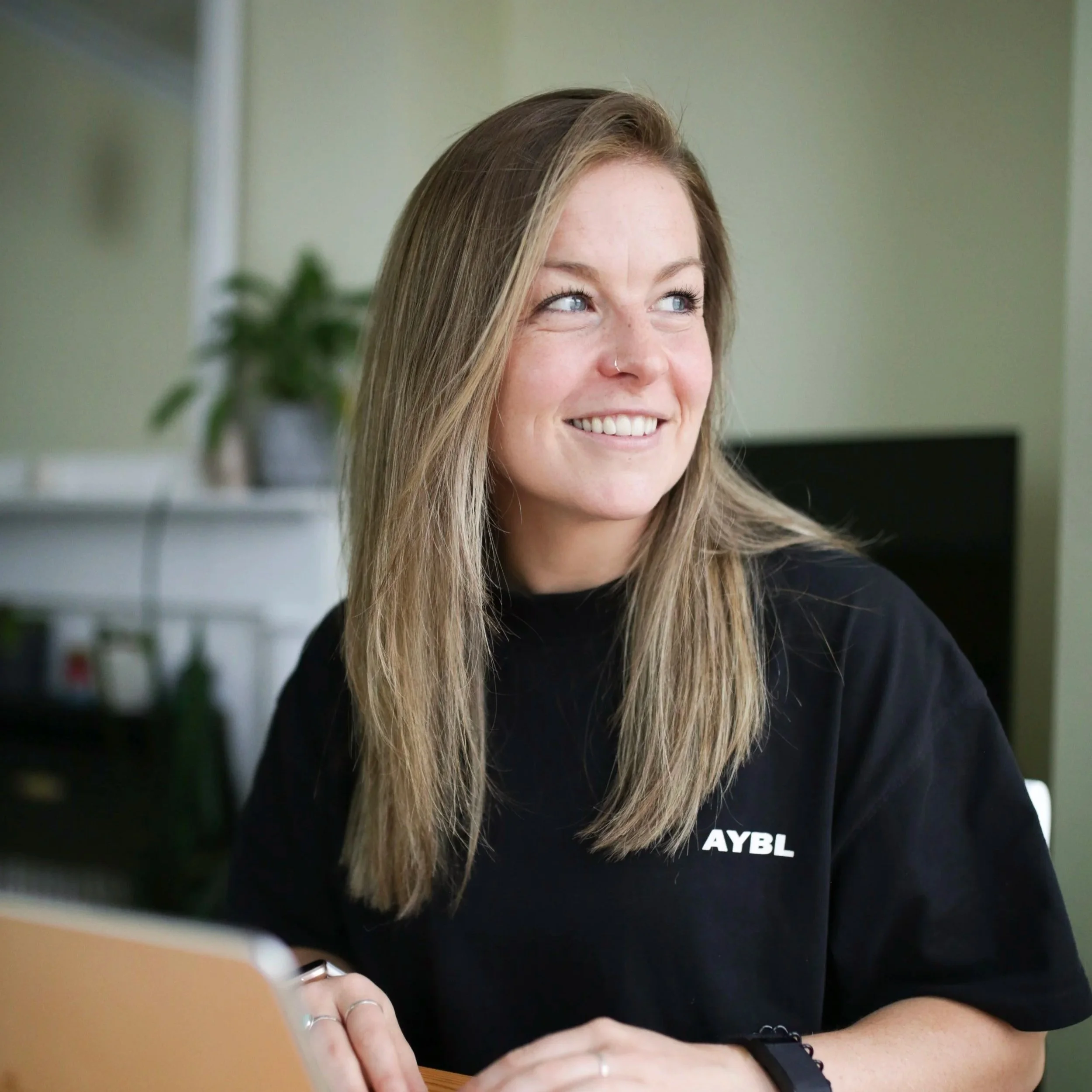An online coach responding to clients in a calm, relaxed environment..