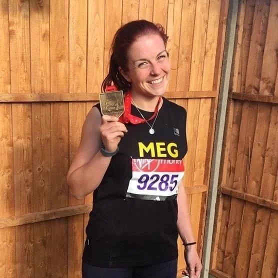 Meg is stood smiling with her medal from London Marathon, the same weekend she passed her personal training qualification. She's happy!