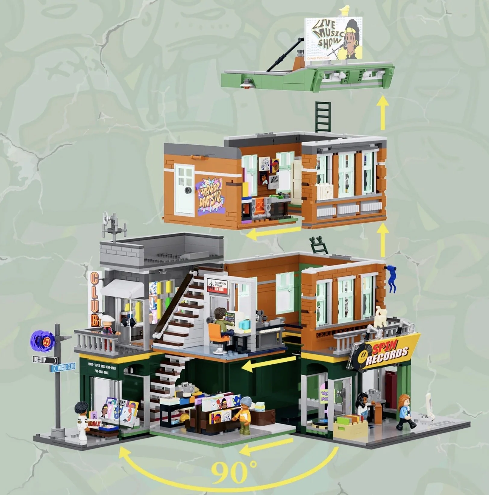 Une maquette de bâtiment composée de plusieurs niveaux, incluant un club de musique, une boutique de disques, un studio d'enregistrement, et une scène en plein air avec un panneau "Live Music Show". Les différentes sections sont empilées et orientées à 90 degrés pour former un ensemble modulable.