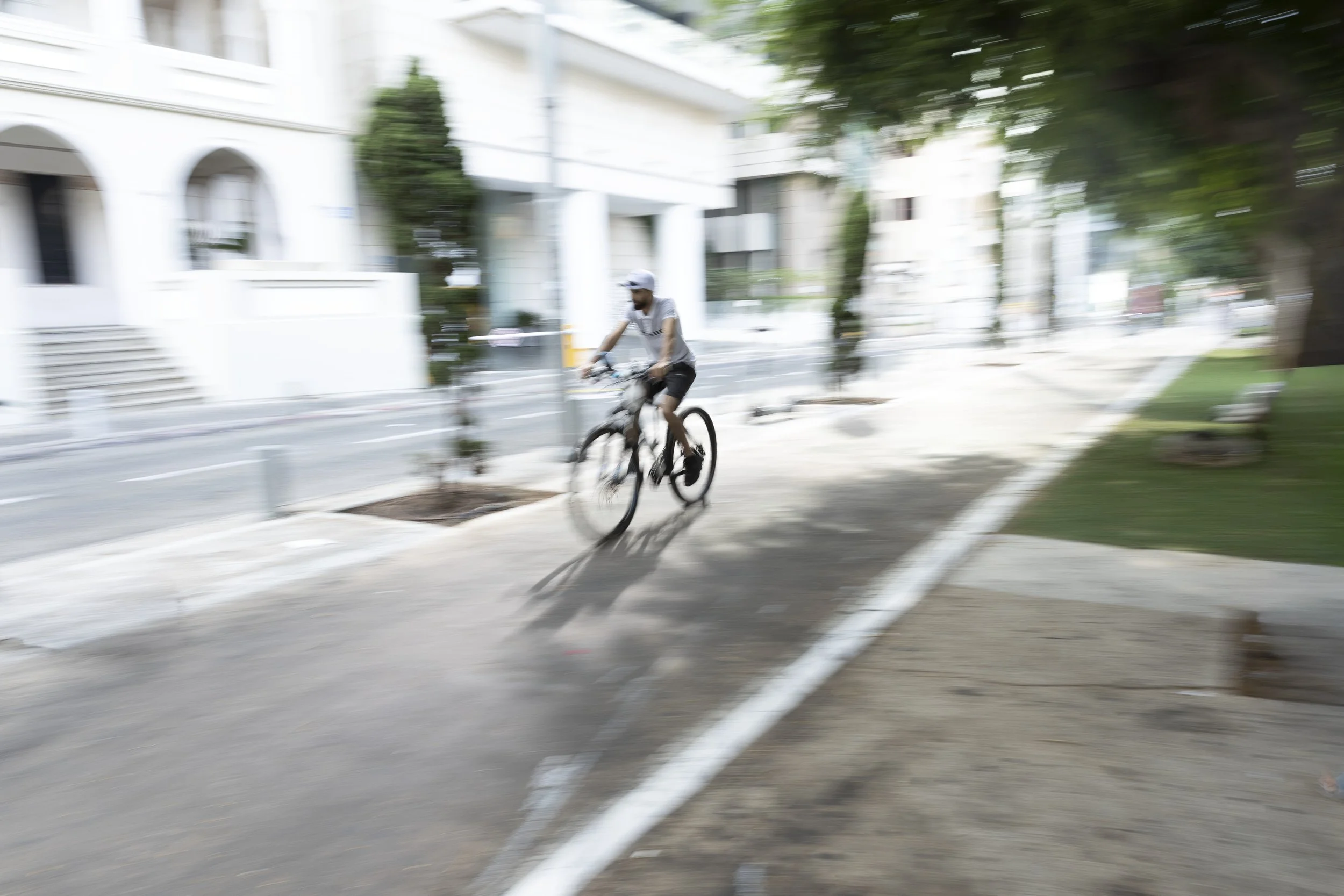 Sarona_Man_riding_bike_lobby_B_120x80 for imaging.jpg