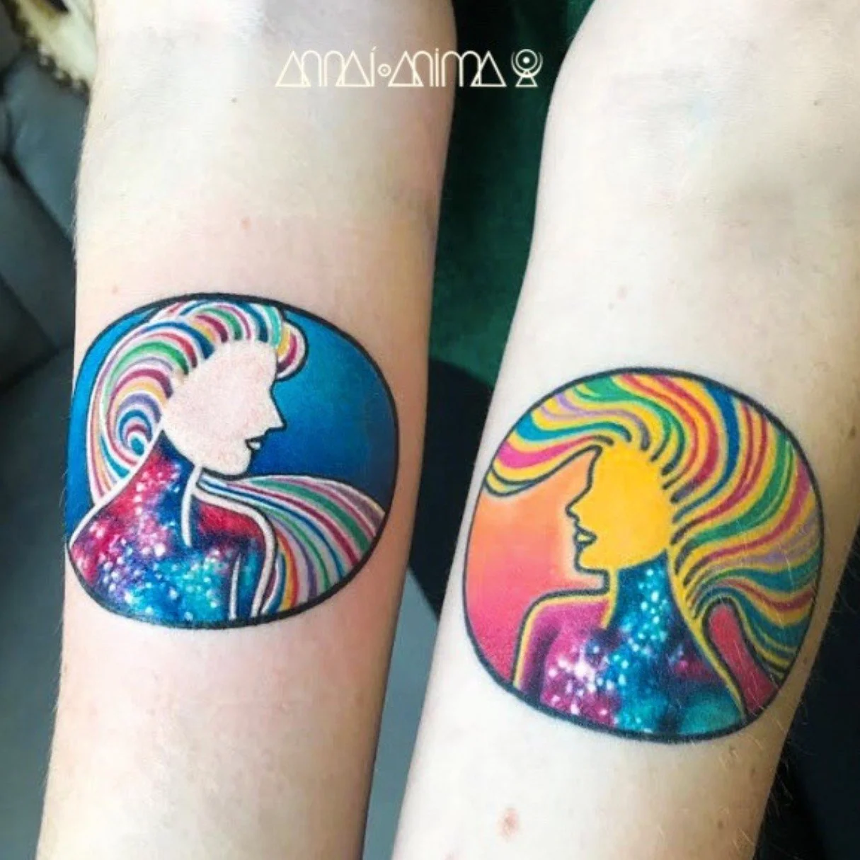 Two colorful tattoos of a woman's profile with long, flowing hair inside circular frames. The left tattoo features a woman with a blue, galaxy-like background, while the right tattoo has a yellow woman with a pink background.