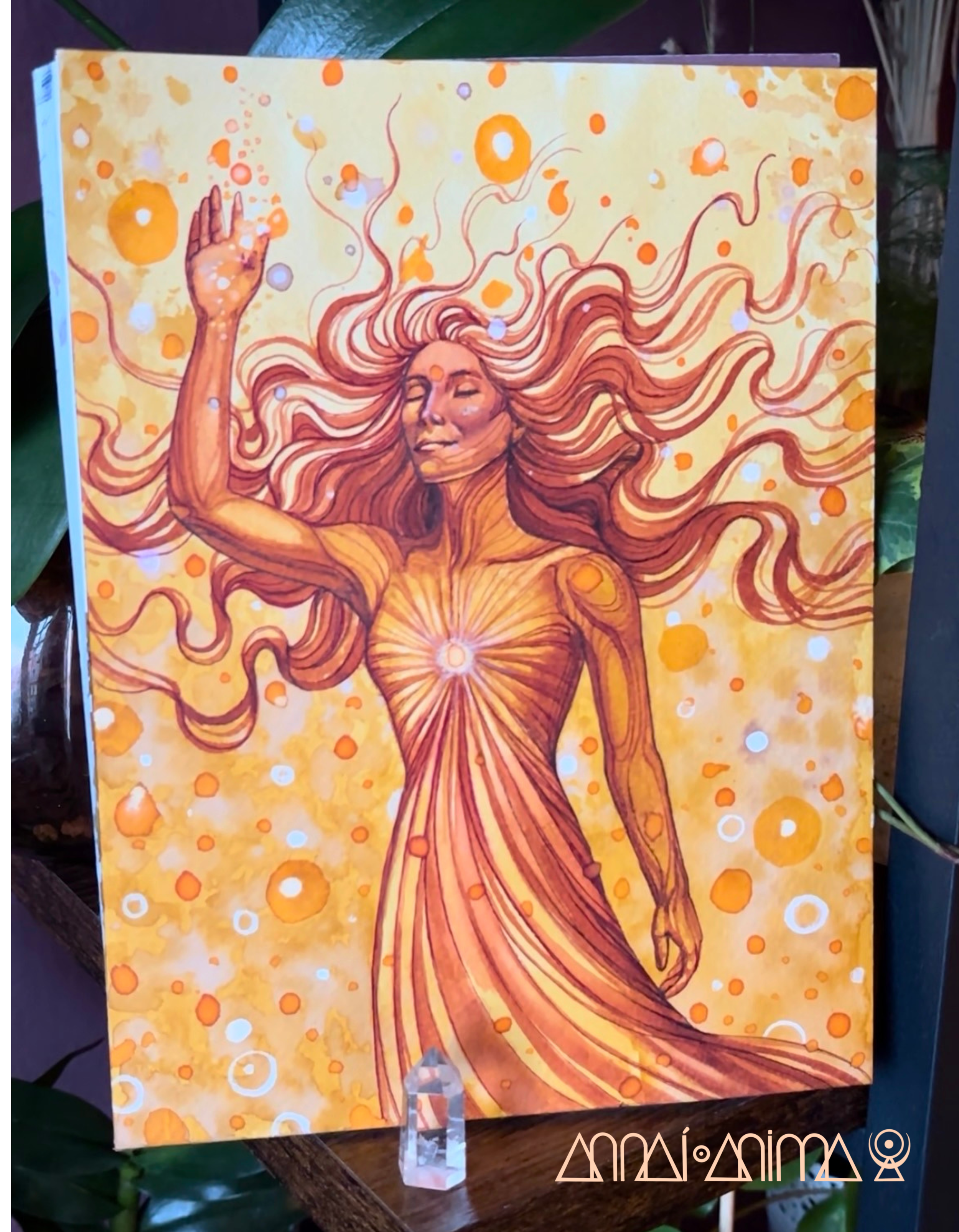 Painted illustration of a woman with long flowing hair, eyes closed, surrounded by warm orange and yellow abstract circles and patterns.