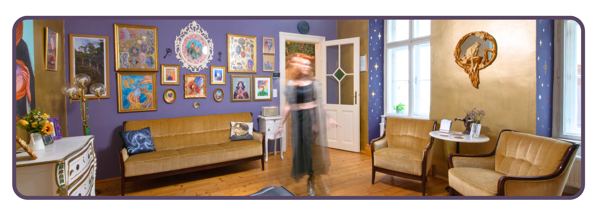 tatuarium studio vienna austria with purple and gold walls, decorated with numerous framed artworks, and featuring vintage furniture including a beige couch and armchairs. A person is walking through the room, appearing blurred due to movement.