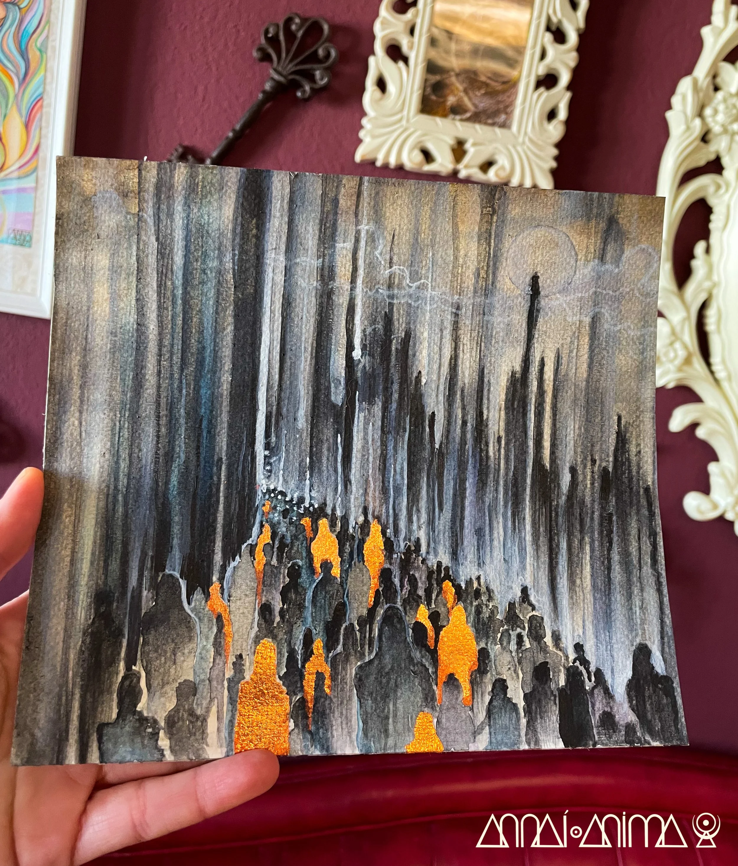 A painting depicting a dark, abstract city scene with tall, vertical structures and silhouettes of people illuminated by orange lights, possibly fires, set against a textured, monochromatic background with a faint moon in the sky.