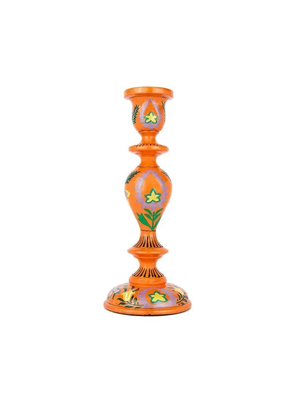 Bougeoir en céramique orange avec motif floral coloré, fond blanc.