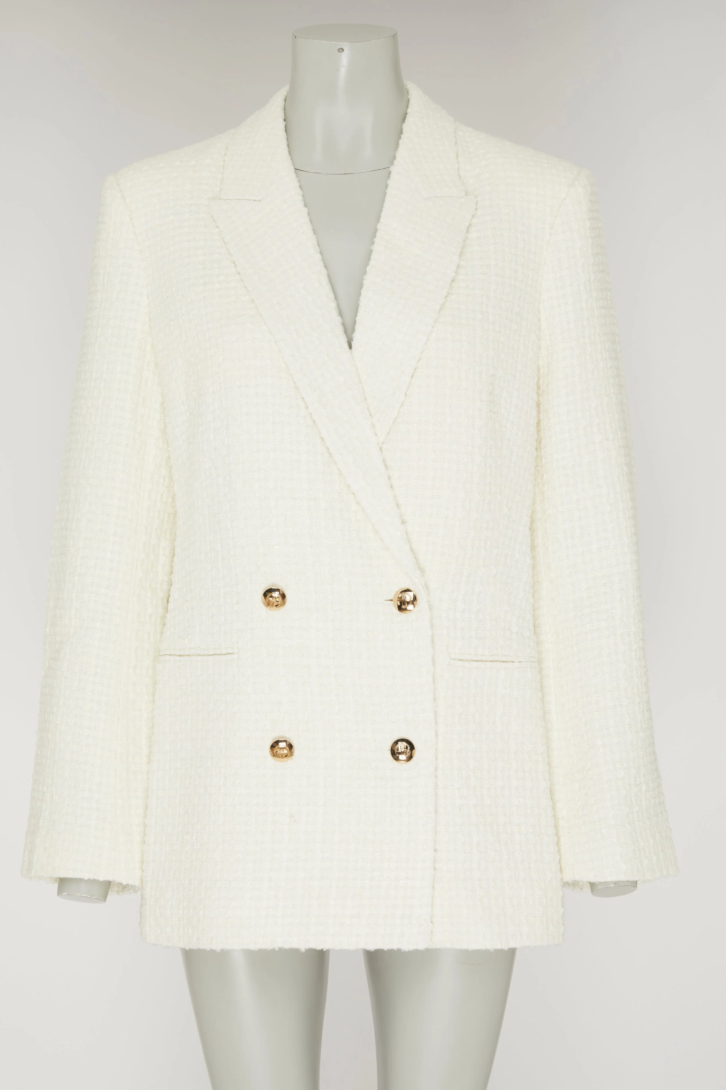 Costume blanc en tweed avec épaulettes et boutons en or, présenté sur un mannequin.