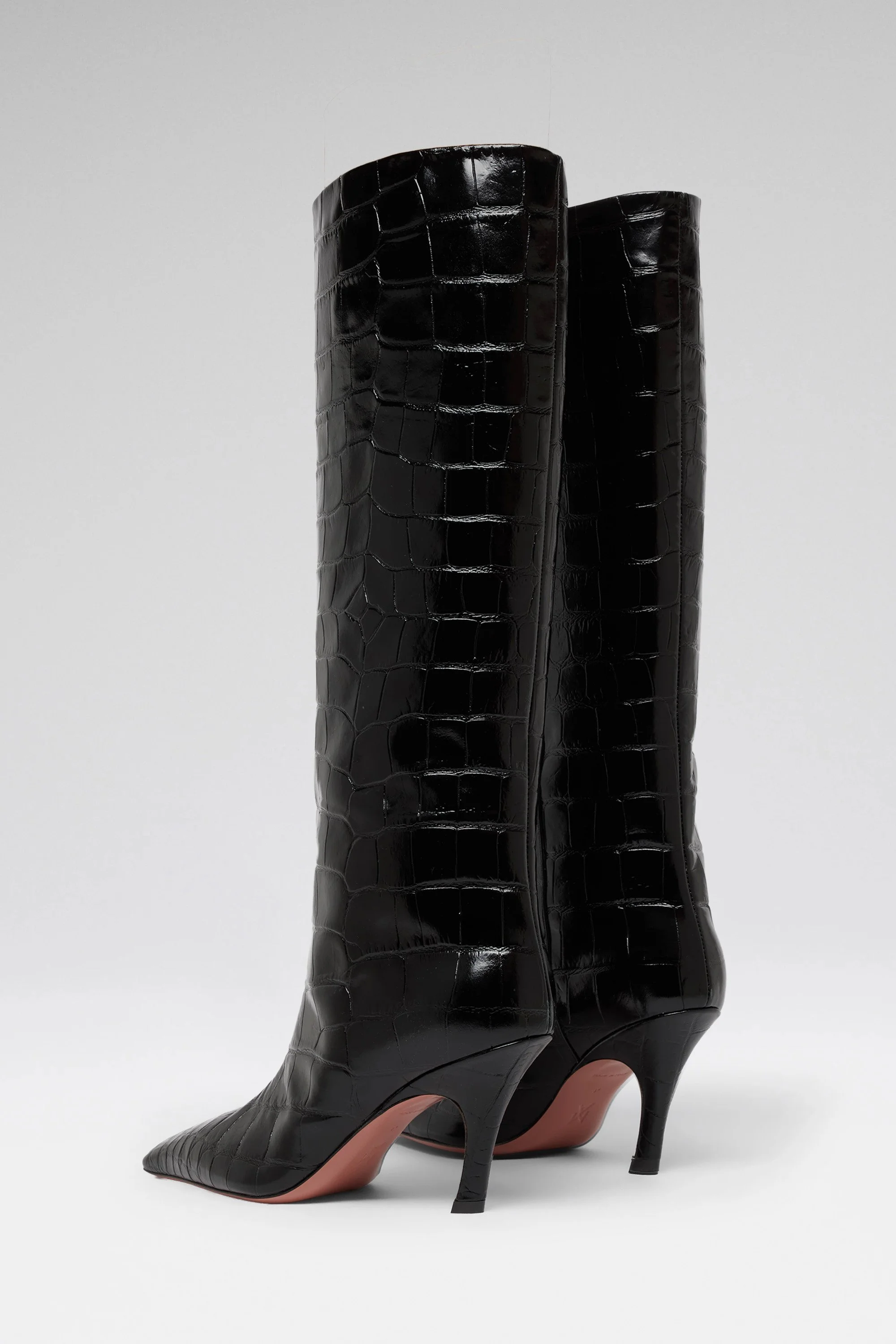 Bottes noires à talons avec un motif crocodile en cuir brillant.