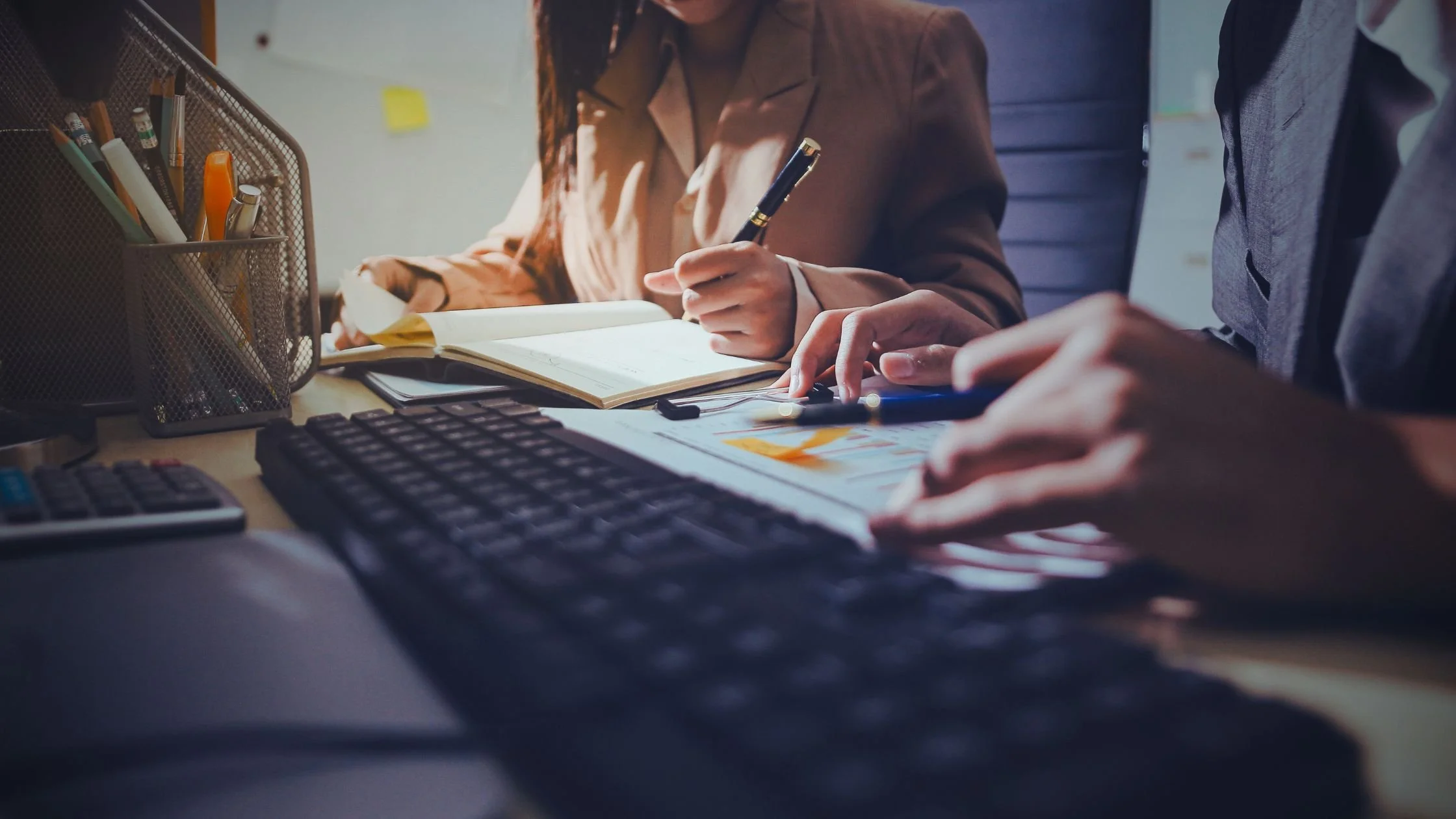 Business professionals reviewing financial documents during an accounting consultation.
