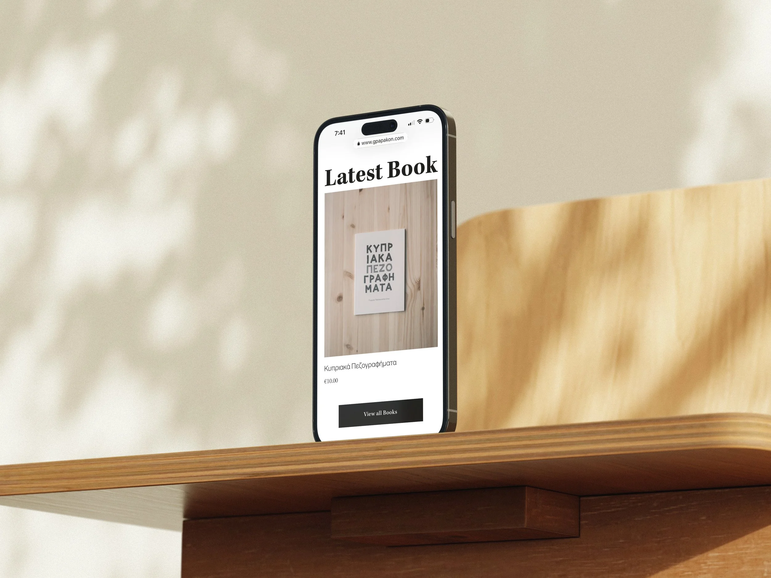 Mockuuups Free iPhone mockup on a wooden desk in sunlight.jpeg