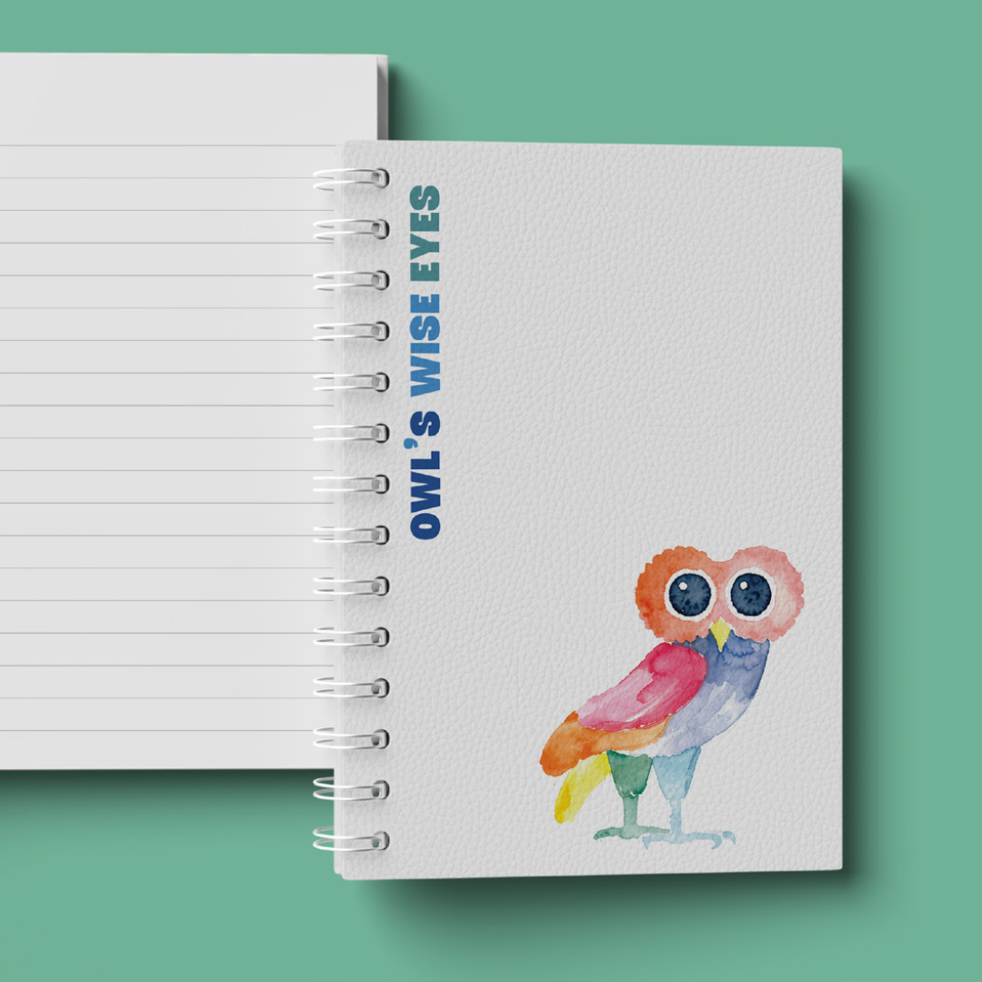A spiral notebook with the phrase "Owl's Wise Eyes" in blue text on the cover, featuring an illustrated watercolor owl with big eyes and colorful feathers, on a light textured background.
