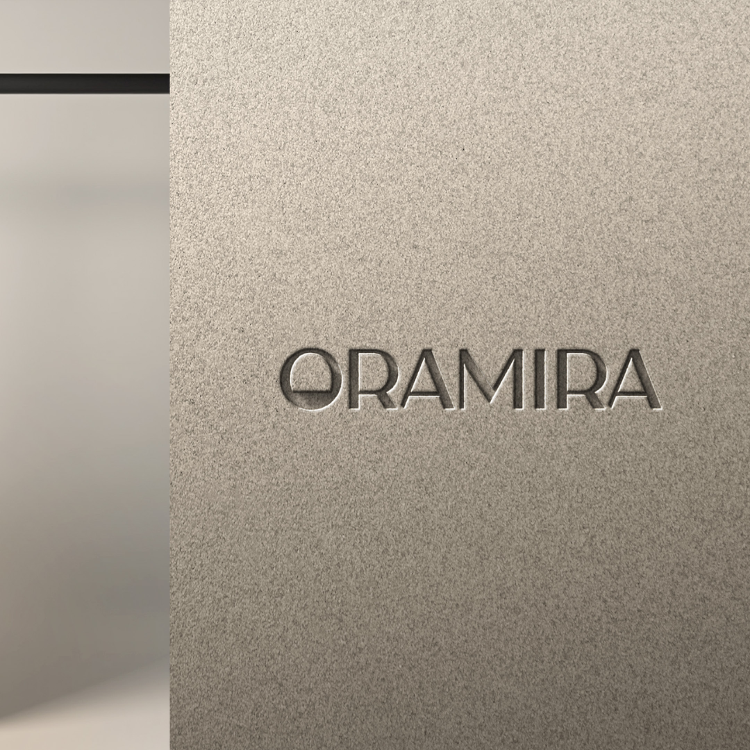 Close-up of a metallic surface with the word 'ORAMIRA' engraved.