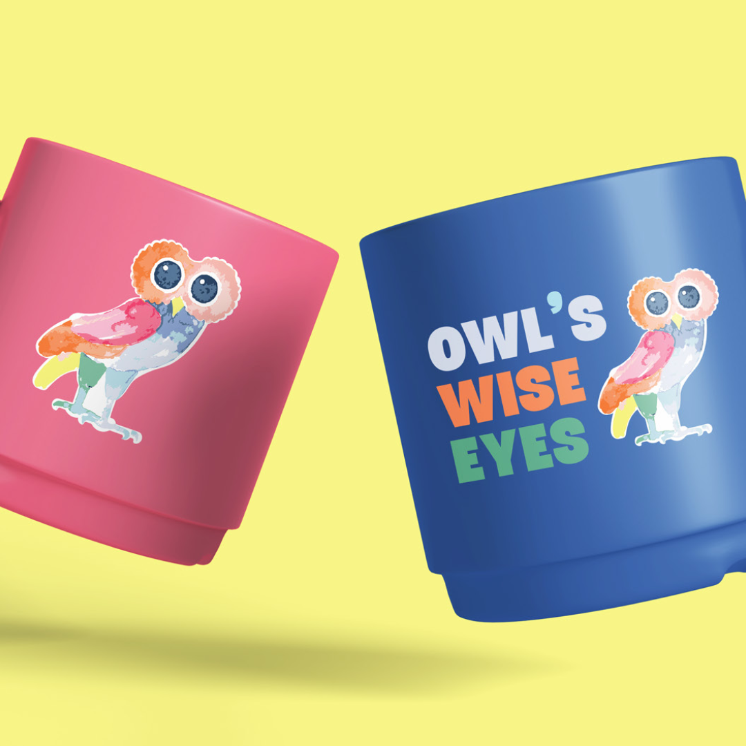 Pink and blue coffee mugs featuring a colorful owl illustration with large eyes, and the blue mug has the text "Owl's Wise Eyes".