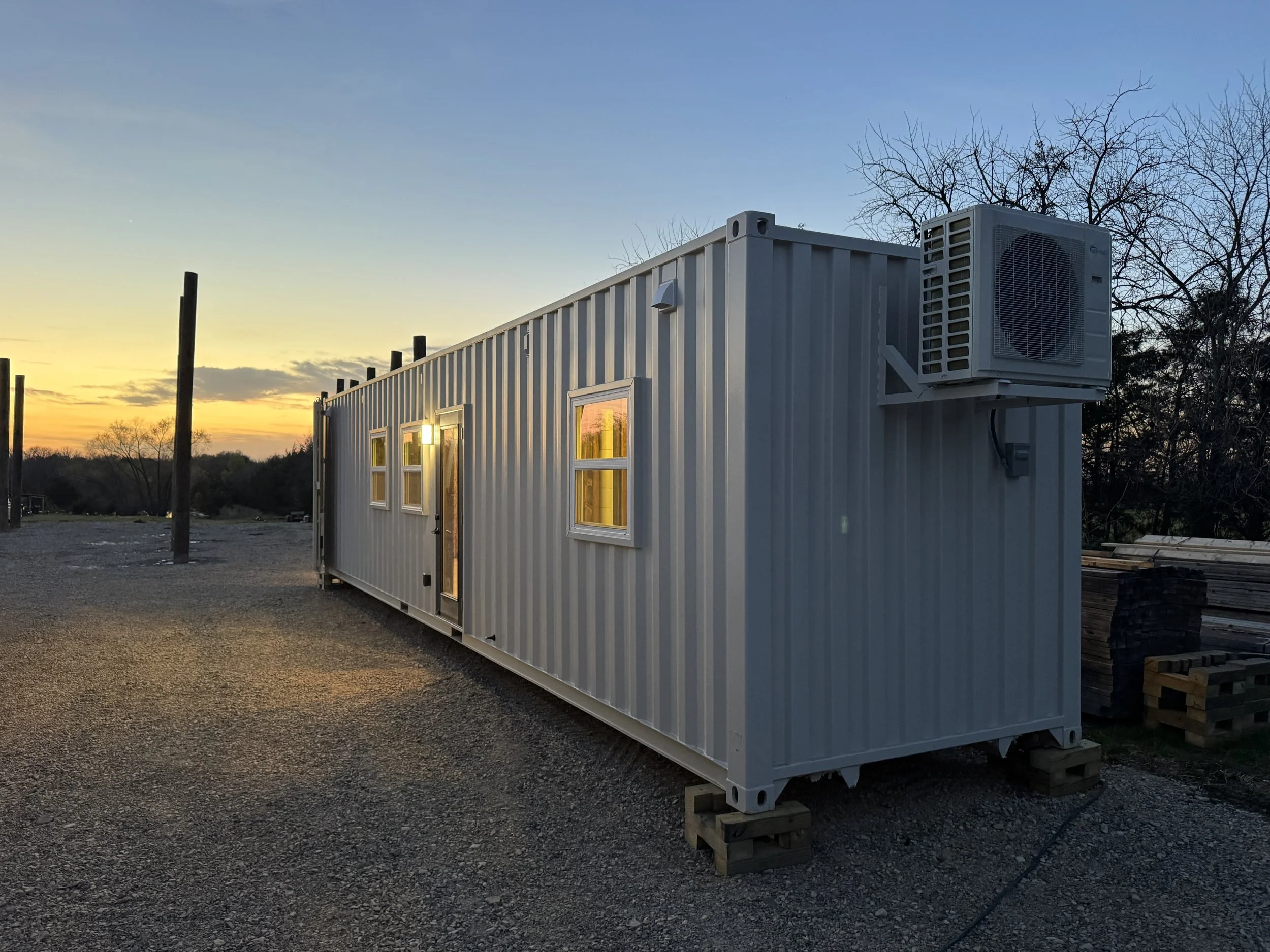 40 ft high cube shipping container home exterior in Paris Texas at sunset with modern windows and entry door